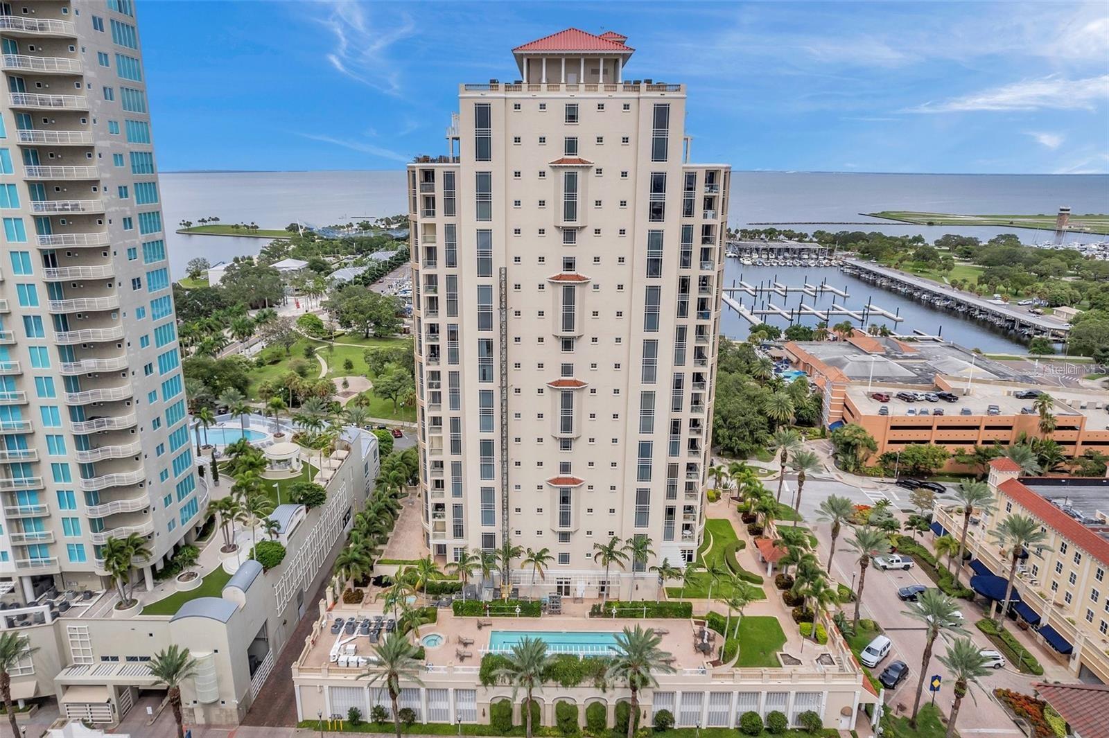 If you're looking to live downtown with unobstructed East water views in a premium location and top quality building, this is your dream home! Discover the luxurious JMC Waterfront Florencia residence in downtown St. Pete, offering nearly 3,000 total sq/ft of remodeled waterfront living space. This exquisite condo features 3 bedrooms, 3 bathrooms, PLUS an office/media room, a gorgeous open kitchen, wet bar, and spacious laundry room.
On the 10th floor, enjoy panoramic water views, high-end finishes, and convenient access with three elevators. The use of premium materials like marble, granite, and wood floors enhances the elegance, while top-of-the-line kitchen appliances elevate the space. Two expansive balconies offer endless views and seamless indoor-outdoor living.
From the moment you enter the 24-hour guarded lobby, you'll experience the ultimate in comfort and security. This building offers an array of amenities, including a heated pool and spa, fitness room, social space with a pool table, and more. The condo comes with 2 secured parking spaces and additional storage. Additional benefits include 24-hour concierge and security, on-site management, and a resort-style pool and spa area.
The location offers a vibrant lifestyle just steps from dining, entertainment, marinas, the new Pier, museums, galleries, waterfront parks, and shopping. Expansive views of Vinoy Basin, the Pier, the airport, and the Dali Museum create a truly stunning backdrop for everyday life. More pictures coming soon!