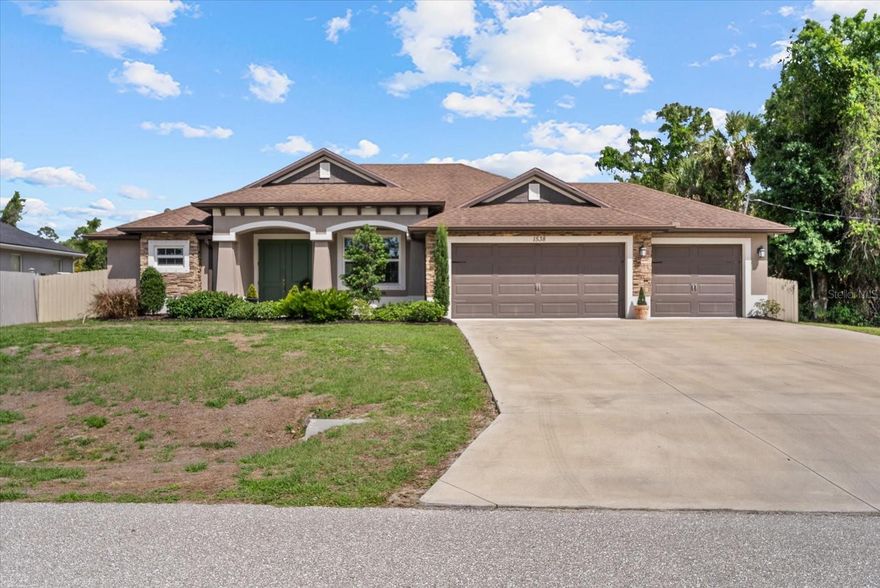 Welcome to this beautifully appointed Zwiercan Homes residence, offering nearly 2,000 square feet of thoughtfully designed living space in a desirable North Port location. Created for both everyday living and entertaining, this 3-bedroom, 2-bath floor plan combines style, comfort, and functionality throughout. The open living area is enhanced by soaring tray ceilings, crown molding, and French doors that lead to an oversized patio with room for a pool. The private owner’s suite is situated on one side of the home and offers two walk-in closets,  along with a spacious, spa-like en suite, and a transom window that fills the room with soft natural light.
The chef’s kitchen is appointed with granite countertops, a tiled backsplash, and stainless steel appliances. Guest bedrooms and the secondary bath are positioned with a private entry off the kitchen, and the bath includes a walk-in shower for added accessibility. Situated on a spacious homesite with no deed restrictions and adjacent to vacant lots on the side and rear, the property offers exceptional privacy and flexibility. The exterior features upgraded landscaping, additional driveway space, a fully fenced perimeter, and a large three-car garage. An advanced water filtration system adds another layer of comfort and convenience.
With its thoughtful layout, upgraded finishes, and prime location, this home is a standout opportunity in North Port. Schedule your private showing today!