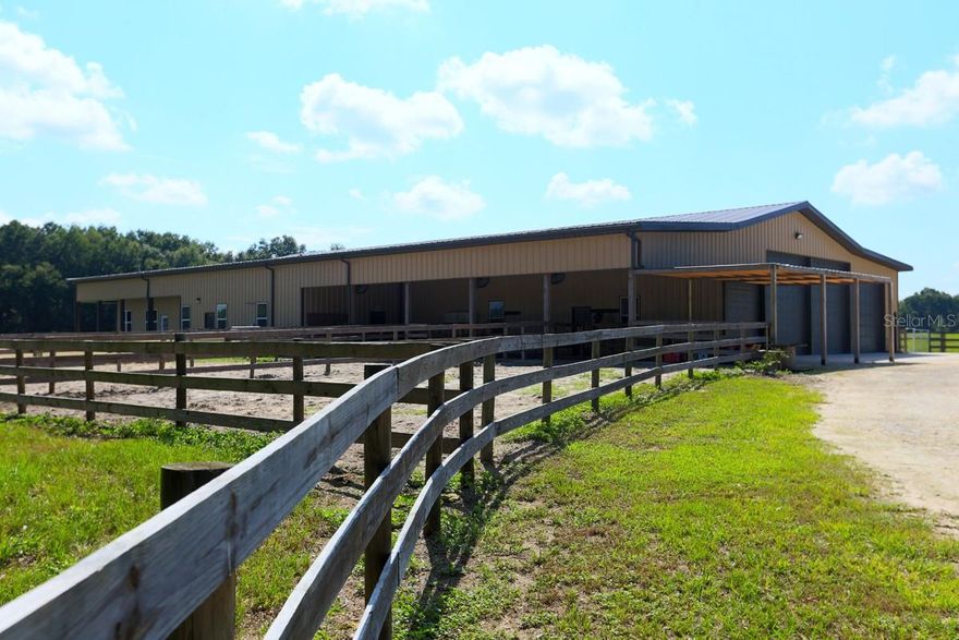 Welcome to a sprawling 75+ acre estate offering endless possibilities. This property offers the best of both worlds - plenty of room to breathe and relax, with all the comforts of a well-maintained business office. Whether you're a horse lover, business owner, corporate investor, car enthusiast, or simply seeking a serene retreat with all the amenities, this property offers endless opportunities. Experience the versatility of this 140 X 80 multipurpose insulated, air-conditioned building with 4 high aluminum roll-up doors providing secure, convenient access to equipment compartments for the 11,200 SF of space, this workshop is ideal for creating an entertainment haven or versatile area tailored to your specific needs.  Divided into sections providing ample parking space to accommodate horse trailers, recreational vehicles, or a car enthusiast's collection and projects. 
A kitchen is equipped with Top-of-the-line appliances, while the central meeting and dining areas, along with patios, offer plenty of space for gatherings, and outdoor entertaining.  Additionally, a quiet and private office space provides an ideal work-from-home environment.  
The property features a 150 X 300 riding arena, working pens, a firepit, a swim spa (designed to incorporate exercise and swimming while enjoying the benefits of massage therapy), 26 KW Generator, and a well, providing for all your necessities. 
Whether your passion is horses or cattle the farm offers room to ride, train, and raise horses or cattle. The property is perimeter-fenced and ready for your cattle, and the location, conveniently situated between Ocala and The Villages, provides easy access to shopping, restaurants, and all other amenities. 
Don’t miss out on this unique chance to own a piece of paradise! Schedule your visit today to experience this unique property.