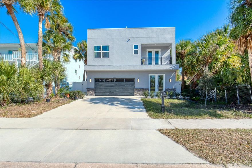Like-new, two-story contemporary home located in the heart of the Daytona Beach Peninsula. Built in 2024, this custom-designed residence offers the ultimate in modern coastal living. The exterior features a two-car garage, a private heated saltwater pool with paver surround, outdoor shower, covered lanai, high-end turf landscaping, and a 6-foot white vinyl privacy fence bordered by exotic succulents and fruit trees. The roof has already been engineered for a future rooftop deck—only a spiral staircase is needed to create a third-level sunbathing or entertaining space. Upon entry, the home welcomes you with 24'' x 24'' porcelain tile flooring throughout. The first level offers a spacious great room, powder room, foyer, and abundant storage, including a built-in closet and under-stair storage. The kitchen area features lower cabinetry, a sink, quartz countertops, and space for an under-counter refrigerator. Also on this level is a full bedroom and full bathroom with a glass-enclosed

walk-in shower, two linen closets, and space for a stackable washer and dryer. This entire lower level was thoughtfully designed to function as a private in-law suite.
Up the oak staircase, the second level serves as a complete second living space and continues the same large-format porcelain flooring. This level includes two guest bedrooms, one currently used as a home office with a wall of built-in, glass-front cabinets. The modern kitchen is equipped with high-end stainless steel KitchenAid appliances, quartz countertops, 42" upper cabinets, accent-colored lower cabinets with soft-close doors and drawers, and a center island that opens to the expansive great room. The great room leads to a west-facing balcony, ideal for enjoying evening sunsets.
The guest bathroom features a corner marble shower, ceramic pedestal sink, and a window that fills the space with natural light. The primary bedroom is situated on the east end of the home and offers its own private balcony overlooking the sparkling pool. The primary suite provides a peaceful retreat with a large walk-in closet and an ensuite bathroom featuring double quartz vanities and a huge walk-in shower that also encloses a jetted Jacuzzi tub.
Completing this level is a full laundry room with a full-size washer and dryer, lower cabinetry, and a utility sink.
This like-new, four-bedroom, three-and-a-half-bath pool home features hurricane-impact windows and doors, 9+ foot ceilings, 8" interior doors, dual HVAC systems, and smart-home features, including app-controlled pool and spa equipment. Also, every room including the exterior balconies are prewired for ceiling fans or light fixtures. Ideally located just minutes from the beach, Intracoastal waterway, restaurants, shopping, parks, and local attractions. Welcome to your private oasis in the heart of it all.