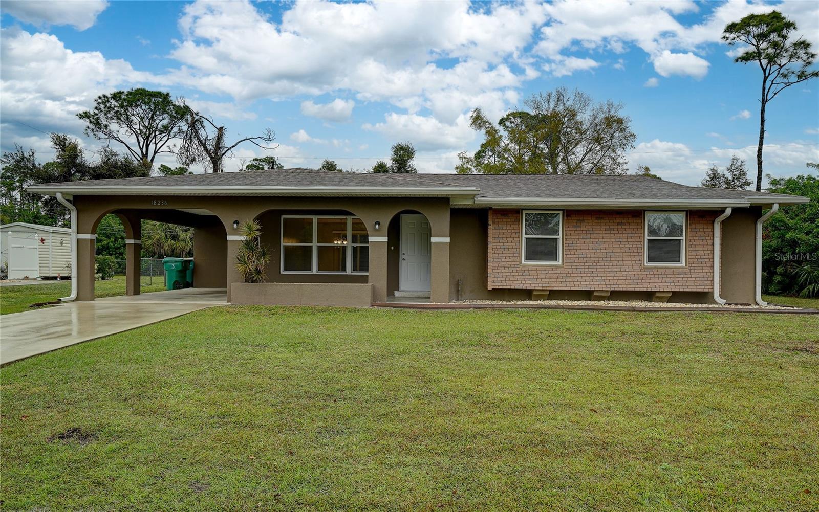 Discover your next dream home! This amazing updated home features an attractive brick front facade and is situated in a prime location, close to Peace River, Myakka River, US41, and several boat ramps. The property boasts a gorgeous fenced-in yard, a spacious driveway, a convenient carport, and outdoor storage. Inside, you'll find an open floor plan with tile flooring in the main living areas, and a versatile laundry room that could easily serve as a fourth bedroom. The kitchen is a highlight, complete with a breakfast bar, raised panel cabinets, quartz countertops, and a pantry. Enjoy the enclosed patio, perfect for relaxing or entertaining. With its proximity to shopping and schools, this home is perfectly positioned for convenience. Schedule your showing appointment today and envision yourself living here! Don't miss out!