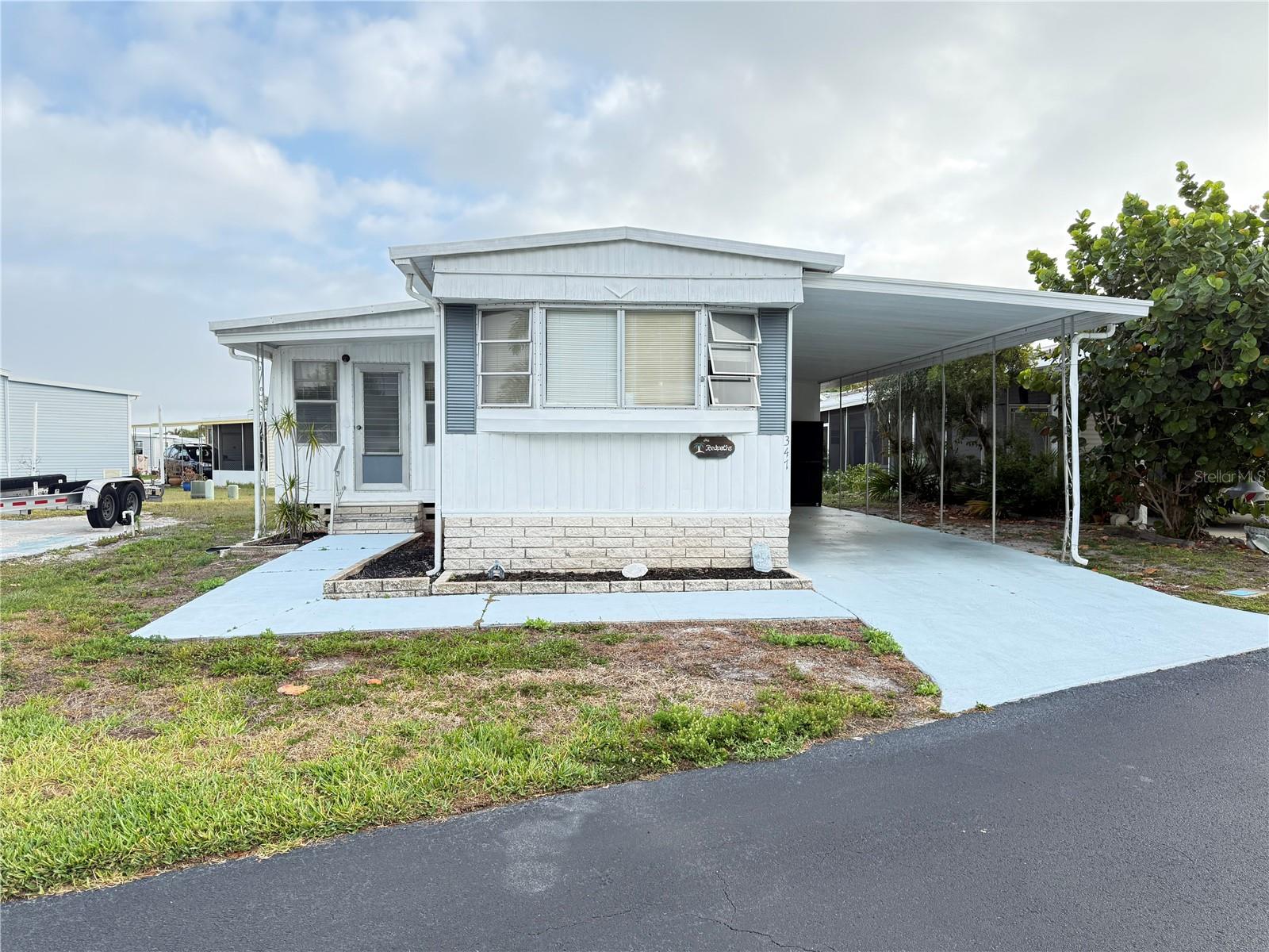 MAKE THIS HOME GREAT AGAIN!!! Great location, close to the boat launch and extra parking. This home had some damage from the hurricanes but has good bones. Home needs a vapor barrier, possibly subflooring and finished flooring. Currently it has no power and needs some rewiring. Look inside, this home has so much potential! 2 mini splits installed in Feb/2024. This 3 bedroom, with bath and a half, comes fully furnished and would make a great home for someone, or 2nd home or investment property, and the price is right!! Enjoy the Florida lifestyle in Americana Cove, a 55+ Resident owned community. HOA $380 includes 24 hr manned gate, water, sewer, trash, and lawn mowing. The community offers a heated pool, newly updated fitness room, shuffle, bocce court, clubhouse, billiards, and many clubs and activities. 675 Credit score required by management.