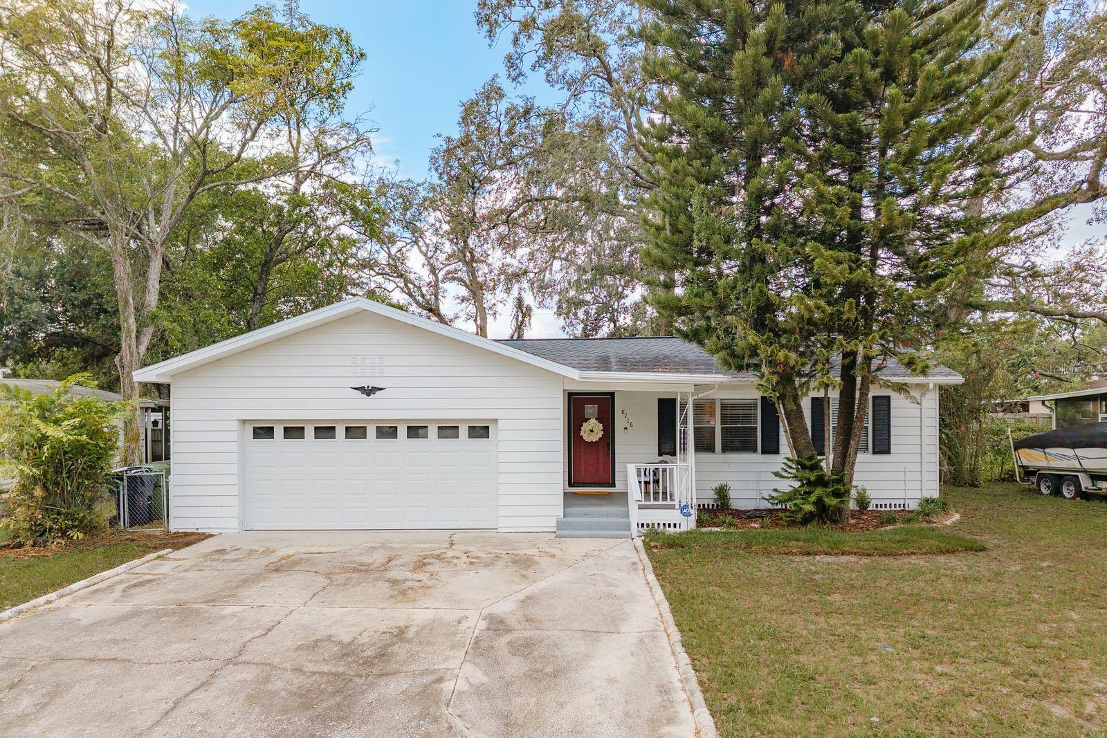 Welcome to this beautifully updated 1949 gem in the heart of Tampa—where timeless charm meets modern convenience. All the work has been done—just move in and start enjoying your new home! This fully remodeled 3-bedroom, 1.5-bath residence is packed with character, starting with a welcoming front porch that invites you inside. Step into a bright, open floor plan featuring original, refinished wood flooring in the dining area and two of the bedrooms—offering a warm nod to the home’s history. The modern kitchen is a true centerpiece, boasting granite countertops, ample cabinetry, a stylish island with additional seating, and updated appliances ready for your next culinary creation. The oversized two-car garage is a standout feature with a premium overhead rack system, its own half bath, and tons of space for storage or a workshop. Out back, enjoy a fully fenced, spacious yard perfect for pets, entertaining, or simply relaxing under the Florida sun. (Roof 2017/ Hot Water Heater 2017/ AC 2017) Ideally located just 30 minutes from Tampa International Airport and 15 minutes from Armature Works, with quick access to major highways. You'll also be just minutes from Lowry Park Zoo, great dining, shopping, and all the conveniences of city living—without sacrificing a peaceful neighborhood vibe. Don’t miss your chance to own this move-in ready charmer—schedule your private showing today!