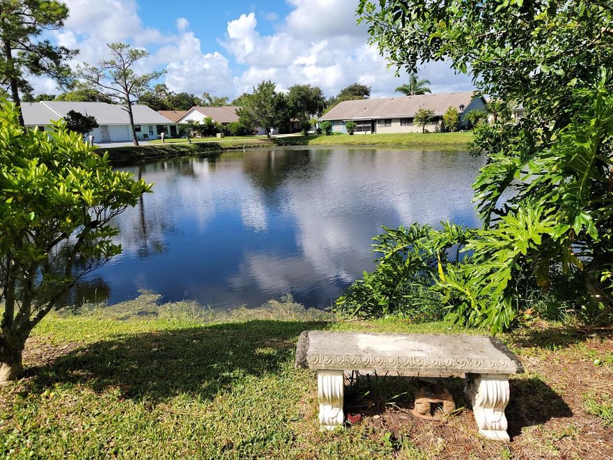Enjoy the Florida lifestyle from this waterfront golf villa, situated in the Fairgreen Golf Community, nestled between 2 golf courses, and within easy, walking distance to  the community heated pool, available by optional and separate membership. This corner unit provides you a tranquil and relaxing place to call home, with vaulted ceiling in the living/dining area and waterproof vinyl planking throughout the living areas. Modern tile floors are featured in the bathrooms and kitchen. Kitchen has been upgraded with canned lights and newer appliances. Spacious master suite features a walk-in closet and lots of elbow room. Both bathrooms have new, comfort height toilets and hall bath shower enclosure has been updated with tile. Full-size Washer and Dryer are in laundry closet for convenience, in the comfort of central A/C. Your screen porch will undoubtedly be your favorite place to relax, with its gorgeous water view. Step outside and enjoy the outdoors, and the tranquility offered by your own little lakeside nook, the perfect place to read a good book, or throw in a fishing line . The outside storage closet offers just the right place for your beach chairs and boogey boards, or make it a small workshop. There are 2 carports, with the one out front measuring a spacious 14 x 19, and the rear carport is 10 x 18. Centrally located, and close to everything, including Historic Canal Street business district, the farmers market, shopping, dining and the beach is but a few minutes away. Affordable $275 annual HOA dues provide you with a mandatory termite bond, water to sprinkler system, as well as operation of the system by the HOA, and maintenance of common areas, including the pond. Some furnishings available outside of closing.  Fairgreen is a great neighborhood, perfect for walking, riding your bike, or ride your golf cart to either golf course. ;Water: City