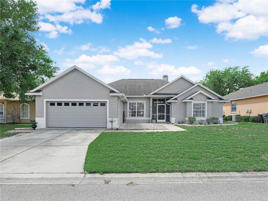 Welcome to Florida living in the gated Benford Heights community of South Lakeland. As you enter, a wide foyer opens to an inviting, open floor plan filled with natural light. The formal dining room features decorative columns and a large picture window overlooking the front yard. The spacious family room boasts a wood-burning fireplace and soaring ceilings, perfect for entertaining. The kitchen includes a snack bar, a closet pantry, and all appliances, while the dinette with windows overlooks the back yard—ideal for morning coffee. Tile floors flow throughout for low-maintenance living. NEW Roof-2021. The main bedroom, with a view of the back yard and a tray ceiling, offers an ensuite with double sinks, a walk-in shower, a garden tub, and a walk-in closet. Inside Laundry room includes washer and dryer and additional storage cabinets. Outside, the expansive lanai invites gatherings, and newer screened pool with automatic cleaning equipment (new pool pump 7/23)  adds year-round enjoyment. The back yard is fully fenced with vinyl fencing, ready for your favorite plantings and outdoor design. Schedule a tour today and make this dream home yours.