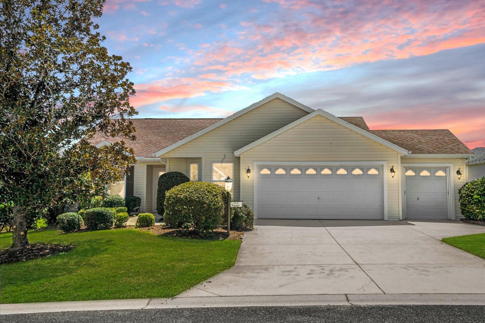 Welcome to this popular Wisteria model in the highly desirable Village of Largo—complete with a full 2-car garage plus a separate golf cart garage for all your Florida lifestyle toys. Tucked in a prime location just off Canal Street, you’ll enjoy a quick and direct route to Lake Sumter Landing, one of The Villages’ most vibrant town squares with shopping, dining, and nightly live entertainment. Step inside to find volume ceilings and an open, airy layout that flows effortlessly. Ceramic tile in all wet areas adds function and durability, while the split-bedroom floor plan offers privacy for both you and your guests. The kitchen features White cabinetry, a stainless steel side-by-side refrigerator, gas range, and solid surface countertops—a clean, classic look that’s ready for your personal touch. The roof is being upgraded with a brand new 30-year architectural shingle roof prior to closing, giving you peace of mind for years to come. Whether you're looking for a seasonal getaway or a full-time home base, this one checks the boxes—and puts you right in the heart of everything The Villages has to offer. Don’t miss this opportunity to add your style and start enjoying life in one of Florida’s most sought-after active adult communities!