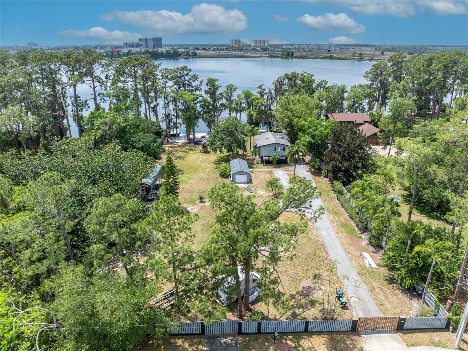 GATED LAKEFRONT HOUSE WITH PRIVATE BOAT DOCK AROUND SEAWORLD! This 3 Bed/ 2.5 Bath single family house features 4.44 ACRES LOT and nested in Lake Willas, one of Orlando HIDDEN GEM. The home boasts an open floor plan that seamlessly connects the kitchen, dining, and living areas, creating a cohesive living space. Each floor has individual kitchen and laundry rooms. Unbeatable location with close proximity to Orlando theme parks, shoppings, restaurants and entertainment, airport, and downtown. All this and NO HOA. Schedule a private showing today and make this beautiful home your new residence or build your dream home at this remarkable LAKEFRONT LOT!