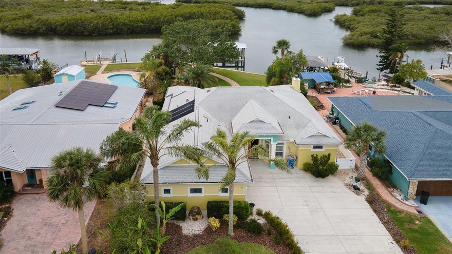 New Smyrna Beach waterfront living at its best in this sweet spot in Inlet Shores which includes a daily sunset over the water. This custom built 3/2 home offers amazing views from almost every room and the backyard waterfront playground boasts an almost 800 sq foot verandah with a summer kitchen, fireplace, retractable sun shades ,noseeum screens, solar heated salt water chlorinated pool and a big backyard that leads to the boathouse on the water. The large deck of the boathouse has been resurfaced, also has a fish cleaning station, water & electric and a boat lift plus an additional floating dock for a second boat or several jet skis. Take your boat out in the deep water canal that is just minutes to the Intercoastal waterway, Ponce Inlet, Disappearing Island and the Atlantic Ocean for superb fishing. The wildlife is amazing as the dolphins, manatees, turtles and fish swim right next to your boathouse daily. Grab your paddleboard or kayak for a fun time paddling amongst our water friends. This Paytas custom built home provides tons of natural lighting, a beautiful kitchen with GE stainless steel appliances plus a dining area that provides a picturesque view of the pool and water, a walk in pantry, Plantation shutters, inside Laundry room, surround sound in the great room and veranda, etched glass, new AC, new waterless hot water heater, inside laundry room which includes washer and dryer, oversized garage where the floor has been coated with 4x epoxy strength flooring along with the front porch, exterior hurricane shutters and this home has had no water intrusion from the hurricanes in part due to the seawall (bulkheads) that is 75 feet long. This oversized Owner's suite has a beautiful spacious walk-in closet, hurricane resistant sliding glass doors with stunning view of the water playground and the en suite bathroom has gorgeous tile and a grande walk-in shower. The owner's suite offer complete privacy with the split plan for the other bedrooms. There is a Library with built in's, a dining room with double doors and the great room provides a tranquil view overlooking the water. Schedule your tour with me today and please click on the video for a true tour of the home. Please go to the video tour also 
https://youtu.be/D4tG_1X_P98 ;Water: City