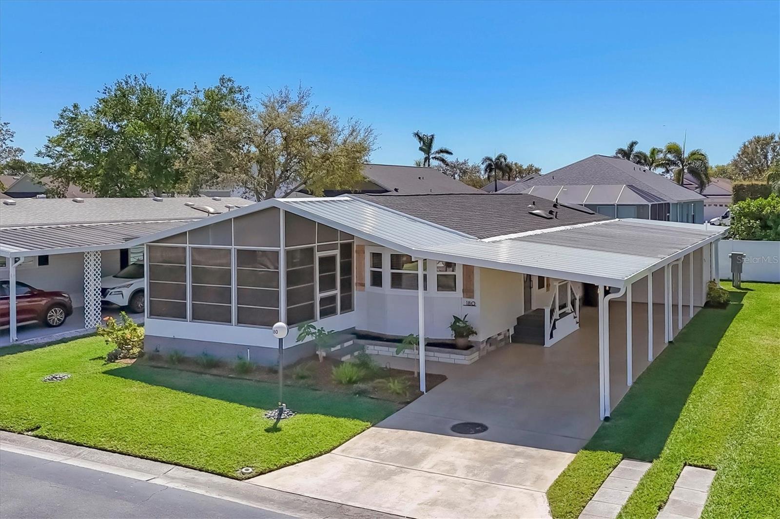 Welcome to your dream home in Gold Tree Mobile Home Community, one of Sarasota’s most desirable 55+ neighborhoods! This fully remodeled 2-bedroom, 2-bath home with an additional office/den checks all the boxes for comfortable, modern living. Step inside and be wowed by the spacious open concept floor plan, flooded with natural light and enhanced by soaring vaulted ceilings and luxury vinyl plank flooring throughout. Crown molding and updated trim add an elegant touch, while large ceiling fans keep the space cool and comfortable year-round. The heart of the home is the custom chef’s kitchen, featuring granite countertops, abundant counter space, soft-close drawers, a designer tile backsplash, and ample storage, perfect for entertaining or everyday living. The adjacent large living area flows seamlessly to your enclosed and screened front lanai, offering serene lake views, ideal for morning coffee or evening relaxation. The extra-large guest bedroom boasts an oversized closet and is served by a stunningly remodeled guest bath. Retreat to your huge primary suite, complete with another oversized closet and a spa-like primary bath featuring a custom shower enclosure, double vanity, and a built-in makeup station. Need a workspace? The convenient office/den area offers flexibility for your lifestyle. Additional perks include a handyman’s dream workshop and storage shed located just off your 3-car carport. This highly sought after perimeter lot gives you tons of privacy too. In addition, you can enjoy peace of mind with these recent upgrades: New Roof in 2022, New A/C in 2020, 14” air ducts, New Vapor Barrier, New Ater Heater, New Irrigation system, and New Sod. Gold Tree offers an amenity-rich lifestyle, including tennis courts, pickleball, a heated pool and spa, fitness center, shuffleboard, and a catch-and-release fishing lake, not to mention an on-site storage yard for your boat, RV, or trailer. Plus, you’re minutes away from the shopping and dining at UTC, SRQ International Airport, Interstate 75, and Sarasota’s world-famous beaches and vibrant downtown. This home is truly move-in ready and waiting for you to start living the Florida lifestyle you’ve dreamed of! Great for Snowbirds with a very liberal leasing policy as well. Schedule a showing today!
