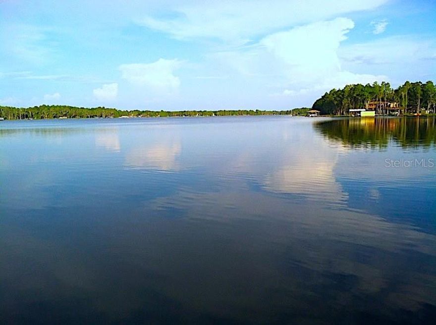 LOCATION,LOCATION,LOCATION Private Gated waterfront home with endless possibilities! Direct Lake Keystone access, one of Hillsborough County's Largest Lakes! This home Is very versatile -whether for a single family or Family with In Law Suite. Bring your Boats,Jet ski's,Fishing Poles etc---even room for RV storage. Enter into the Large Great room with direct views to the Lake. Large Formal Dining Area and enormous Kitchen! Plenty of sliders welcoming the outdoors in ,covered and screened patios/ The Main Home has 4 bedrooms. Large Master suite cover the whole upper back of home with 2 Balconies. Large Walk in closets and Large Master Bath. Large 2nd Master suite located on the First floor-tucked away for privacy yet also has a Lake View. At the Front of the home is a Very Large Apartment with Full Bath and Bedroom. Plua 3 Car Garage !Enjoy Beautiful Sunsets !!