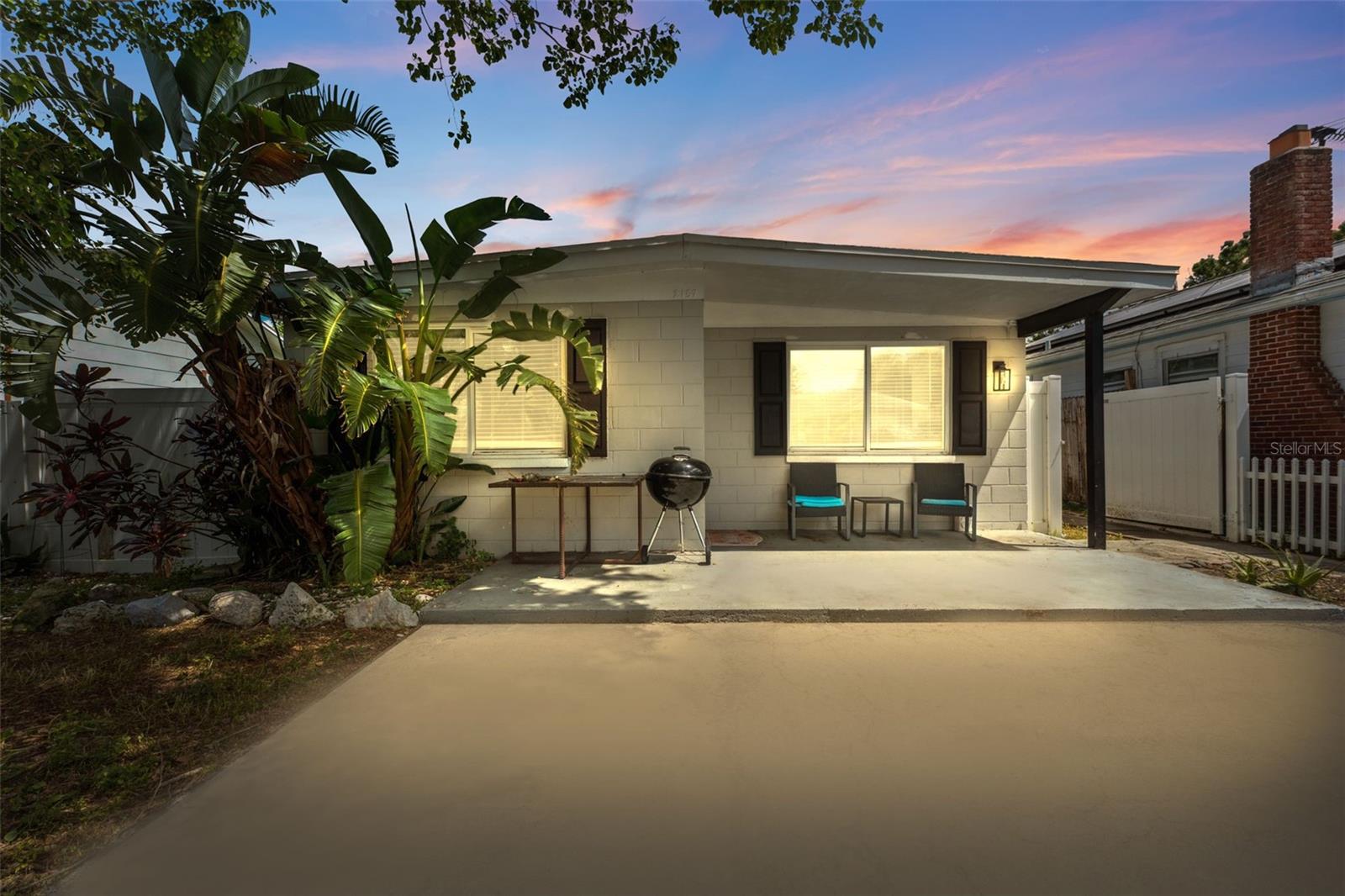 Assume a 2.25% interest rate VA loan! This home also qualifies for a 1% lender credit for traditional buyers. Turnkey 3 bed 2 bath block home just 5 minutes from 4th Street in St Petersburg. This beautifully renovated property features an open concept layout with wide plank engineered wood flooring, a large granite island with bar seating stainless steel appliances, and a designer range hood. The updated kitchen includes white shaker cabinets, a custom backsplash, and a spacious pantry. Enjoy a bright and inviting living area that flows seamlessly from the kitchen perfect for entertaining. The interior laundry room includes a newer Samsung washer and dryer. The primary suite offers a deep walk in closet, and a fully remodeled en suite bath with modern tile and finishes. Both bathrooms have been tastefully updated. Major system upgrades include HVAC 2022, roof 2019, and electric panel 2020. Additional highlights include dual pane windows and plenty of off street parking with a large concrete pad. The fenced backyard offers space for outdoor living or pets. Whether you're a first time buyer or looking for a rental ready investment this solid block home is move in ready in a convenient St Pete location.