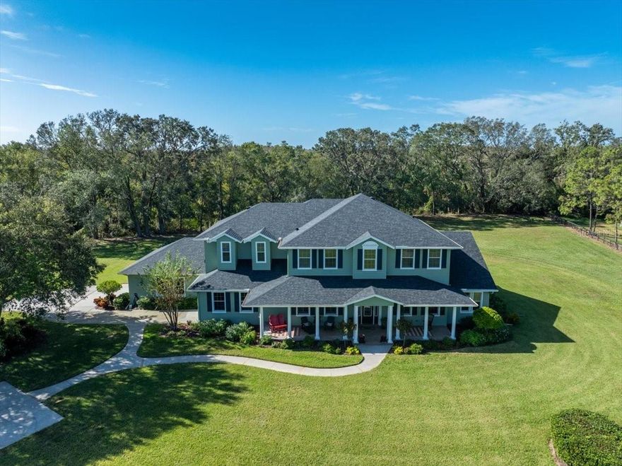 We are pleased to present this MAGNIFICENT, ONE OF A KIND EQUESTRIAN ESTATE PROPERTY IN ODESSA, FLORIDA! Situated on over 22 ACRES AND BACKING TO CONSERVATION, this 4 Bedroom, 4.1 Bath, custom built home (Horizon Homes) with Office, Bonus Room, and 4,971 sq. ft. of incredible living space awaits you at the end of a LONG, PICTURESQUE, TREELINED DRIVEWAY. The many features of this property include: an inviting front porch that prompts you to just want to sit back, relax, and stare out at the GORGEOUS LAND AND FENCED PADDOCKS before you; a light and bright, open floor plan with spacious rooms, volume ceilings and neutral décor; a BEAUTIFUL KITCHEN with butler’s pantry, GAS RANGE, granite counter tops, stainless steel appliances, and enormous walk in pantry; a spacious, first floor primary suite with updated bathroom and large walk in closet; French doors, hardwood floors, plantation shutters, crown molding and 2 stair cases; a show stopping great room fireplace; an upstairs BONUS ROOM with wet bar and spacious enough for a pool table and sitting area; STORAGE CLOSETS; an inviting HEATED POOL/SPA package with large lanai and retractable awning; 3 car side entry garage; a SEVEN STALL BARN with tack room and work shop; a pole barn big enough to shelter a tractor and trailer; irrigation system (covers the paddocks as well as the landscape around the house); NEW ROOF (2023) and HOUSE GENERATOR (2020); flood insurance not required and no damage from hurricanes of 2024; immaculate interior/exterior condition and more! Add to these NO HOA or CDD fees, a convenient location to great schools, shopping, dining, parks, medical facilities, interstate and airport travel, and you have a fantastic place to call home!