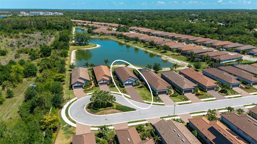 Highly sought after Arezzo model in the gated community of Bellacina by Casey Key is being sold TURNKEY FURNISHED. Located on a quiet cul-de-sac with breath taking water views, this 3-bedroom, 2 bathroom + den is a designer's dream. Spacious open floor plan with custom features from top to bottom: from higher ceilings with crown moldings in most of the home including all the trey ceilings, plantation shutters throughout, 20 X 20 ceramic tile laid on a diagonal and designer ceiling fans in most of the rooms. Beachy Coastal Decor gives you the feeling of living on the beach, while you're just minutes away. With abundant natural light coming through the windows all day, the Great Room features exquisite long lake views through your 8 ft sliding glass doors out to your extended lanai with Picture View Screen. New 65-inch Samsung TV with full motion wall mount included. Gourmet Kitchen includes custom cabinetry, quartz countertops, subway tile backsplash, wood shelving in the pantry, pendant lighting over your Breakfast Bar and stainless-steel appliances including gas cooktop range. Primary Bedroom en-suite features walk-in closet and spa like bath, that includes dual sinks, Corian counters, private water closet and walk-in glass shower. The guest bedrooms are nicely decorated and well arranged with both built-in and walk-in closets. Sharing the 2nd bathroom is easy with dual sinks with Corian counters and tub with shower combination. Additional Den can be used as an office, man cave/craft room or for a quite time reading a good book. Laundry room is separate with plenty of storage cabinets, utility sink and folding counter space. The home is situated farther back from the street than most, giving you more privacy and a closer proximity to the lake. Along with an extra-long driveway to accommodate your extended family and friends. Never a dull moment with Bellacina's resort style amenities including clubhouse with fitness center heated pool and spa, pickleball, tennis and bocce ball courts, dog parks and full-time activities director. You can even jump on your bike and hit the Legacy Trail with gated access. Convenient location close to dining, shopping and local beaches. With this beautiful home being sold TURNKEY FURNISHED all you'll need to bring is your toothbrush.