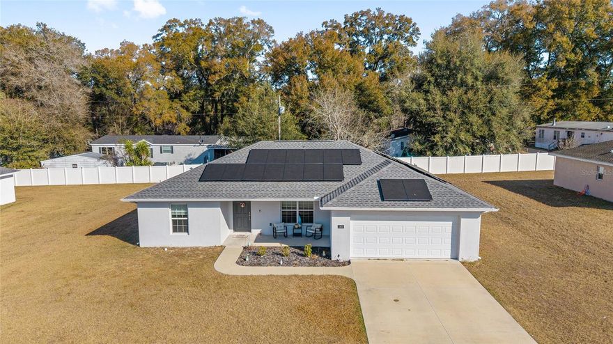 Please allow me to introduce this well-maintained three-bedroom, two-bath, two-car garage home built in 2021 by Triple Crown. Offering 1,437 square feet of living space, this newer home is tucked away on a quiet dead-end street in Citra and is ready for its new owners.

Designed for comfort and efficiency, the property features energy-efficient solar panels to help keep electric costs low, along with added gutters for improved drainage and exterior protection. Smart home features provide modern convenience and peace of mind.

Inside, you’ll find an open floor plan that flows seamlessly into a spacious kitchen equipped with granite countertops, stainless steel appliances, abundant cabinet space, and a large bar area perfect for entertaining. Both bathrooms also include granite finishes, giving the home a cohesive, upgraded feel throughout.

Located in a quiet neighborhood, this home offers comfort, security, efficiency, and style all in one.

Call today to schedule your private showing.