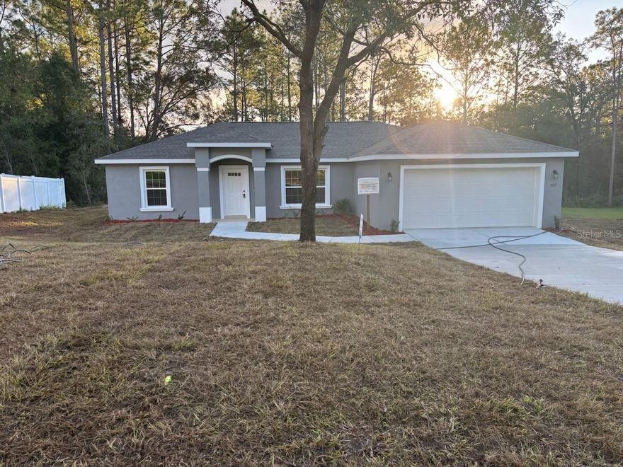 NEW CONSTRUCTION. MOVE-IN READY! Introducing the all-new Isla Bella Model, a beautifully designed 3 bedroom, 2 bathroom home offering 1,530 square feet of comfortable living space. Built with durable concrete block construction and topped with a 30-year architectural shingle roof, this home combines style and strength. The open-concept layout features a spacious living room with a vaulted ceiling and energy-efficient double-pane windows that fill the space with natural light. The deluxe kitchen includes a large layout with custom white shaker cabinets, soft-close drawers, a subway tile backsplash, stainless steel appliances, and granite countertops. The master suite offers a luxurious retreat with a tray ceiling accented by crown molding, a large walk-in closet, and an oversized 5x5 walk-in shower with dual shower heads, a privacy window, and two linen closets. Both bathrooms feature upgraded marble-look tile, and the main bath includes a relaxing tub/shower combo. Luxury vinyl plank flooring runs throughout the home, and the laundry room comes with an upgraded cabinet package. Enjoy outdoor living on the covered patio, and appreciate the convenience of an attached 2-car garage with opener and remotes. With no HOA fees and a location in flood zone X, this property is high and dry and does not require flood insurance. Backed by a 10-year structural warranty, the all-new Isla Bella Model is the perfect blend of comfort, quality, and modern design.