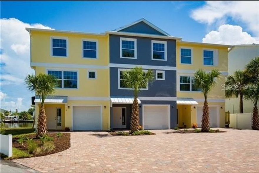 Stunning waterfront townhome just steps from the beach! Built in 2017 using all reinforced block construction.  It is a boutique 3 unit condo association that is self managed.  This building is also exempt under florida condo law from the mandate to have an SIRS ( structural integrity reserve study) done.  This elegant three-story residence offers the best of coastal luxury, durability and easy maintenance. Enjoy effortless living with a private residential elevator that services all levels. All hurricane rated windows and slider. Nestled on a wide, deep sailboat canal, this home provides direct access to open water and embodies the Florida boating lifestyle. This location is 2-3 minutes to the intercoastal waterways by boat . The townhouse includes a deeded double-wide boat dock (30 AMP electric service and water connected) with a 16,000 lbs boat lift, a Jet ski swinger lift as well as a 2 spot floating jet ski dock. For security, there are ring cameras: one on the front door and one monitoring the backyard and the boat slip. Two Sea-Doo™ jet ski's are available for sale, as a separate purchase.

Beautifully furnished with solid Tommy Bahama and other high-end pieces and is offered fully finished and move-in ready. Second floor, all neutral, large ceramic tiles and an open floor plan. A beautiful kitchen with granite countertops, Huge stainless steel farm sink, stainless steel KitchenAid™ appliances and a walk-in pantry. Large living room overlooking the water through a large balcony. This floor also has a large room that can be used as a formal dining, office or a fourth bedroom with a half a bath, with granite countertop, a solid wood vanity and a huge wall closet.  This home is ideal as a full time residence or a comfortable, inviting beach retreat. Third floor has the primary bedroom with the primary bathroom ( on suite) with granite dual sinks, a stone floored large shower with a shelf and a shower seat. A frameless glass shower door makes this bathroom most elegant.  Two guest bedrooms, beautifully furnished and each has a large wall closet, share a bathroom with a tub, floor to ceiling tiles and a built in shelf. The residential elevator is a huge convenience getting your groceries and items from your car to upstairs. Oak stairs from the beautiful entrance to the second floor. Lush carpet hugs your feet as you go to the third floor. Two car tandem garage with lots of room for storage and a workshop. Garage floors, just been all coated with a neutral light color epoxy coating. 
Just a few minutes walk to the sugar-sand beaches of Indian Rocks Beach, a walk to local shops and restaurants and 30 minute drive from 2 area airports.   With this townhouse's location, build and condition you’ll enjoy the perfect blend of relaxed coastal charm and upscale comfort.