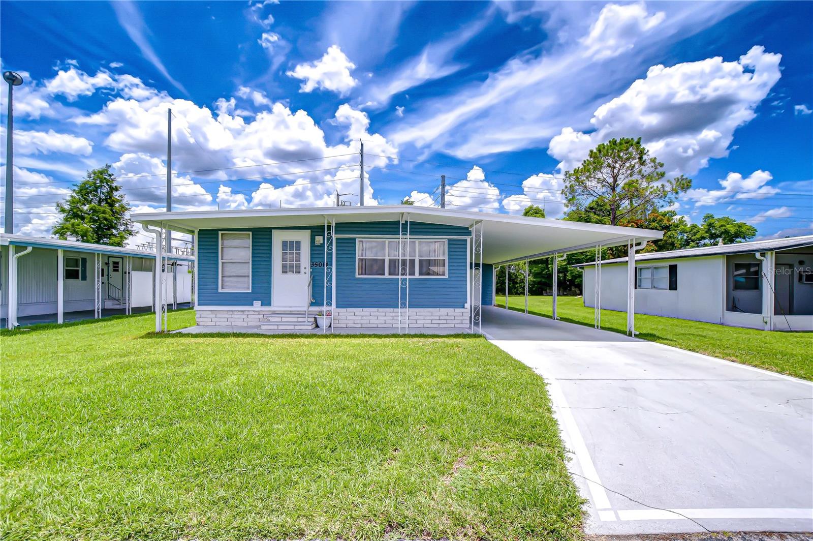 Charming & Move-In Ready – Affordable Senior Living! Welcome to this super cute and clean 2 bedroom, 1 bath singlewide with an addition, located in the desirable 55+ community of Zephyr Shores. This home offers a bright, open floor plan that’s perfect for relaxing or entertaining. An added bonus room, complete with an electric fireplace and TV provides extra space for guests or a cozy spot to unwind. Some furnishings will stay, making it easy to move right in and start enjoying your new lifestyle. The exterior of the home is just as inviting, with updated and well-maintained siding that gives great curb appeal. A covered carport offers convenient parking, while the shed provides washer and dryer hookups, tool storage, and even a private covered patio area to enjoy your morning coffee or evening breeze. Zephyr Shores is a wonderful community offering a pool, clubhouse, and plenty of activities to keep you as busy and social as you'd like. With low HOA fees, you own your land here — no high lot rents to worry about. Conveniently located near both Wesley Chapel and Zephyrhills, you’re close to shopping, dining, medical facilities, and just a short drive to Tampa, Orlando, and Florida’s beautiful beaches. Whether you're looking to retire, snowbird, or simply downsize, this well-cared-for home is ready for you. Don’t miss your opportunity to make it yours!