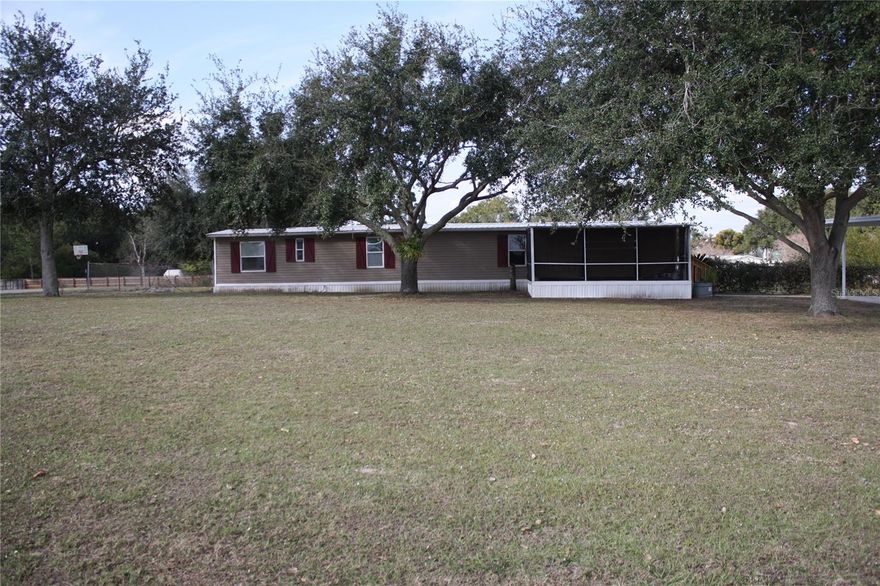 Enjoy this property located on .95 acre. This 3 bedroom 2 bath is perfect for a starter home or that person looking for out of city limits living with plenty of room for a workshop, pool,boats and more in the fenced backyard. The front of the home offers a carport for your vehicles and a spacious front screened porch. Upon entering you will find a cozy living room with a nice size kitchen with plenty of cabinets. On this side of the home is also a bedroom complete with its own bathroom as well. A second bedroom is just steps down the hallway.The laundry is also located in the hall with cabinets where you will also find the rear door to a patio. To the end of the home is the master bedroom with a large walk in closet and also has a spacious master bathroom as well. This home is conveniently located by FL-570 with quick access to schools,eating shopping and attractions.