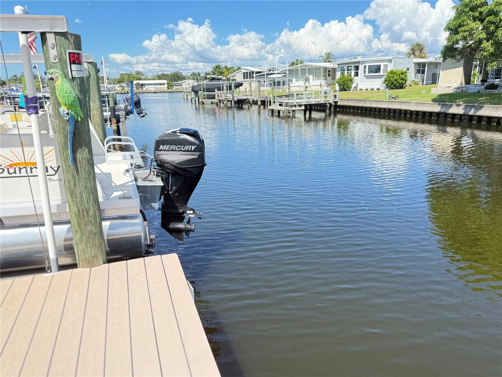 Enjoy waterfront lifestyle in this beautiful 3-Bedroom, 2 Bath home with just under 1300 sq ft, built in 2004. At 9 ft above sea level, this home is high and dry and had NO damage from previous storms. The open floor plan has a WOW effect as soon as you enter the large family room with the high ceilings and transom windows, providing lots of natural light! There's a nice eating area adjacent to the kitchen. The galley kitchen has lots of cabinets and most appliances were updated in 2024. (AC, Vapor Barrier & Ductwork 2024). Water heater (2023) and Refrigerator (2022). The far end of the kitchen leads to the lovely Florida Room, overlooking your own composite dock (2015) and lift. The Master bedroom (20 X 20) has a large walk-in closet and additional area suitable for crafts and/or private office or computer. Step outside through the glass sliders in the master bedroom to a small, railed porch to sit and enjoy the morning sunrise. The spacious en-suite bath has a garden tub and separate shower and double sinks. Washer and dryer (2024) are located in large shed with lots of additional storage, and there is also an enclosed storage area for a golf cart adjacent to the carport. With 3 bedrooms this home offers enough room for family and guests and strikes a good balance: not too small and not overly large to maintain. The waterfront canal offers pleasant breezes, sunrises to enjoy and dolphins and manatees to watch. Located in Americana Cove, a Gated 55+ community with many amenities: clubhouse, fitness center, pool, shuffleboard, bocce, 2 boat ramps and many clubs and recreational activities, including water access to Tampa Bay with no bridges. HOA $380 includes water, sewer, trash, manned gate, and lawn maintenance. It's all here!
This is a MUST SEE! Make an appointment today.