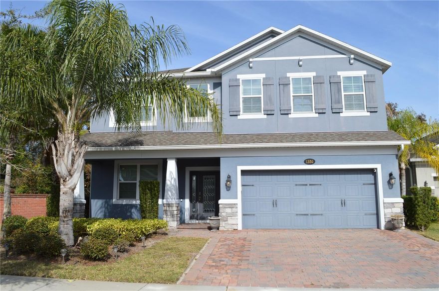 Former model home featuring a stylish open-concept layout with two primary suites (one upstairs, one downstairs), formal dining, a spacious second-floor loft, and a covered lanai overlooking a tranquil in-ground pool. The gourmet kitchen offers cabinetry, GE stainless steel appliances including built-in double ovens, quartz and granite countertops, and a large waterfall-edge island. Interior upgrades include wood and tile flooring throughout, custom built-ins, designer bath tile, and a brick accent wall in the loft. Energy Star 3.1 certified and built to M/I Homes Whole Home Standards, featuring Core Fill block insulation, R-38 ceiling insulation, Low-E windows, full perimeter rebar, raised heel trusses, and a 3,000-psi concrete foundation for long-term efficiency and quality construction.