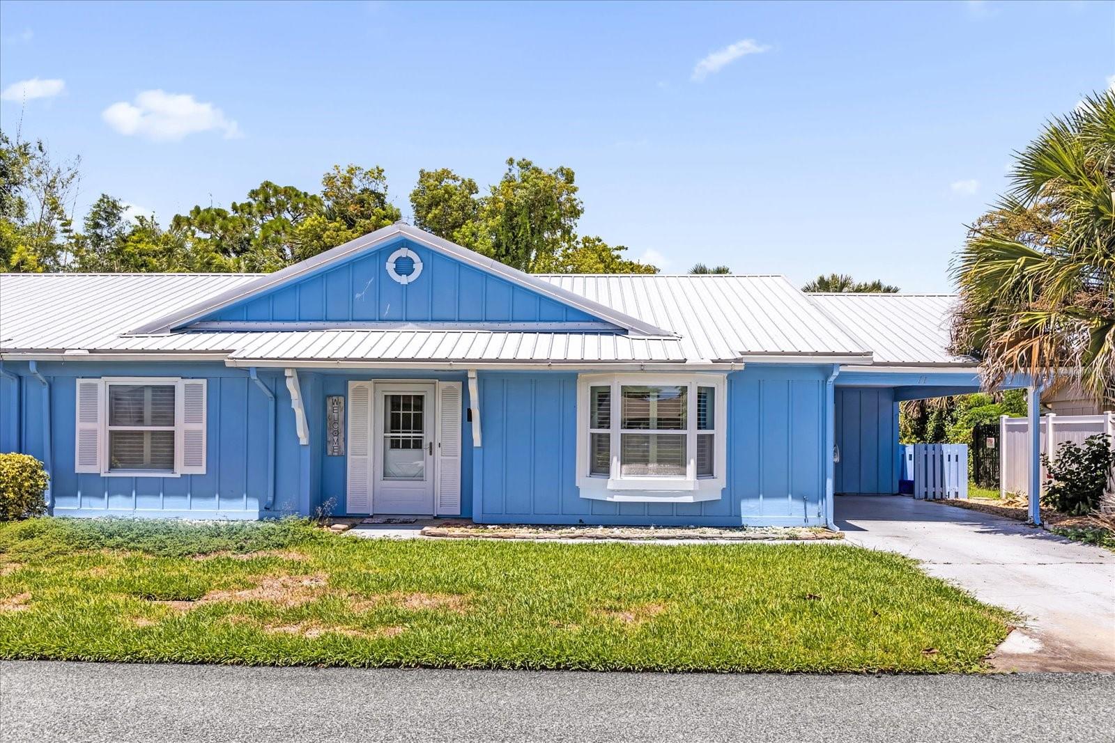 Live the low-maintenance lifesyle with super reasonable dues just minutes from the beach! This adorable 1/2 duplex is situated on a canal front lot in the wonderful Fairgreen community. Includes access to the community pool (not all do!) This spacious 2/2 feautures a newer metal roof, plantation shutters and wood-look laminate throughout most of the home. The layout includes spacious bedrooms, great room and eat-in kitchen. The primary suite features two closets! Relax in the large private porch off the back surounded by nature. Fish in your own backyard! A large, full-size laundry room with washer & dryer can be found off the carport. This terrific community is just 11 minutes from Flagler and the beach! HOA includes termite bond.