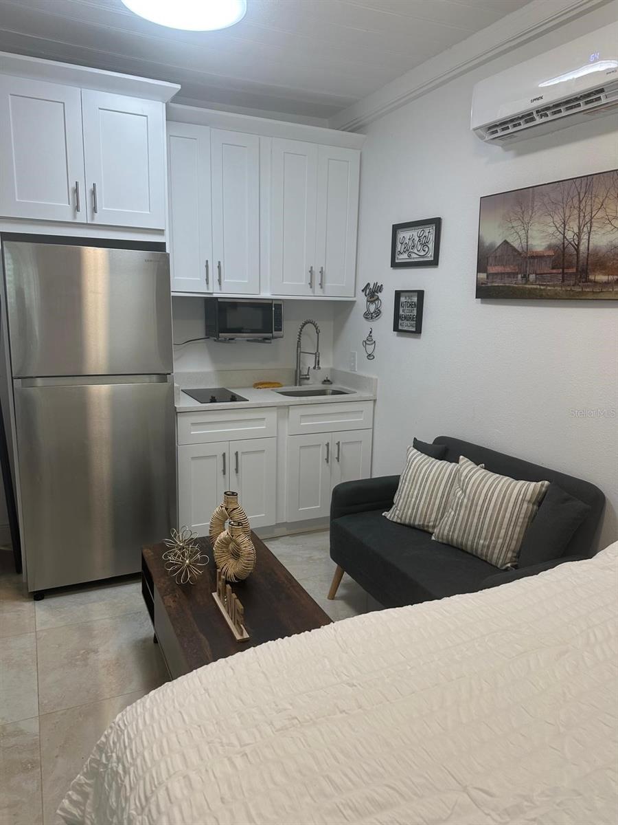 Discover this new and fully furnished studio apartment, designed for comfort and convenience. Thoughtfully styled with modern finishes, this move-in-ready space includes all furnishings, along with utilities—water and electricity—covered in the rent. Located less than 30 minutes from the world-famous Disney theme parks, you'll enjoy easy access to top-rated restaurants, shopping, and entertainment. The apartment comes equipped with a flat-screen TV, refrigerator, mini cooktop, and microwave, making it ideal for anyone seeking a low-maintenance lifestyle in a prime location. Don’t miss out—schedule your showing today!
