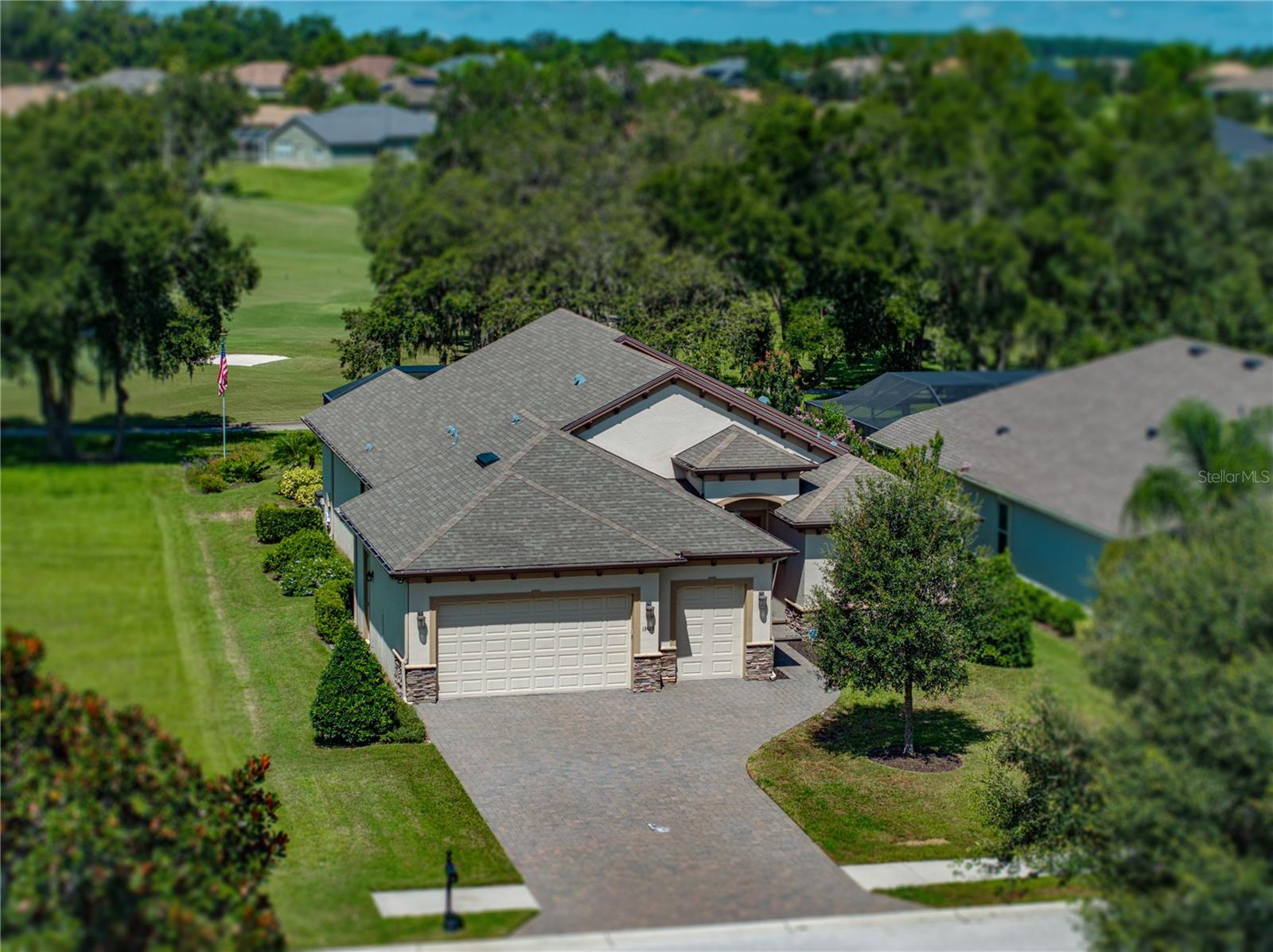 Luxury living at its best! Located amongst the tranquil rolling hills of renowned Lake Jovita Golf & Country Club, this custom-built home sits on an absolutely gorgeous, premium golf-front lot with expansive views of the groomed fairways, ponds and massive Grandfather Oaks on our South Course. The floorplan is well designed with an open great room that includes the kitchen, a dining nook, a large dining area with wall sconce lighting and a spacious family room with a decorative built-in for the mounted television and electric fireplace. The home also features 4 bedrooms and 3 full luxury bathrooms, with ample private space for guests, a large laundry room, loaded with beautiful cabinets, a laundry sink and a hobby desk, plus an extended 2-car plus a golf cart garage. The dream kitchen features a large cooking island with bar seating for 4, high-end KitchenAid appliances, a Wolf 6-burner gas cooktop and exhaust hood, beautiful 42” cabinets with crown molding, instant hot water faucet and a huge hidden pantry with custom wood shelving. The great room enjoys abundant natural light and wide-open views, thanks to the wall of glass that leads to the lanai oasis, with its sparking pool and spill-over fountain. This fabulous lanai is enclosed with a heavy-duty, panoramic screen structure and has lots of room to take in the sun, plus a large, covered space, accented with a stunning, dark stained wood plank ceiling and 2 ceiling fans to relax in the shade. The roomy primary bedroom has a large sitting area, two spacious walk-in closets with custom shelving and a gorgeous ensuite bathroom with a private water closet, dual sinks, a massive quartz countertop, complimented with wall-to-wall cabinetry and a huge walk-in shower with floor-to-ceiling tile. The home is highly upgraded with beautiful hardwood plank flooring and many other tasteful accents, including crown molding, 5-inch baseboards, quartz countertops and tons of storage in the numerous closets throughout the home. These owners spared no expense when building the home and added many other special features and upgrades such as: 12’ ceilings in the welcoming foyer and great room, a tankless gas water heater, energy efficient and fire-retardant Icynene attic insulation, an attic storage area, a water softener, instant hot and filtered water at the kitchen sink, USB ports in the island, automatic on-off switches in the pantry, primary bedroom closets and laundry room, and a dedicated circuit for golf cart charging. This is a must-see home in a must-see community!! LAKE JOVITA is the best kept secret in the Tampa area. Live the resort lifestyle in our uniquely beautiful, gated, resort community with super low HOA dues, two championship golf courses, tennis courts, fitness center, community pool, basketball and pickleball courts, a beautiful park with paved walking path, a playground and separate dog parks for small and larger dogs. We are conveniently located near excellent shopping, restaurants, medical & educational facilities, and unlimited entertainment options. Located only five miles from I-75, with easy access to other major highways and two international airports. Don’t miss your opportunity to own this distinctive home and enjoy all that Lake Jovita and the Greater Tampa & Orlando Region have to offer.