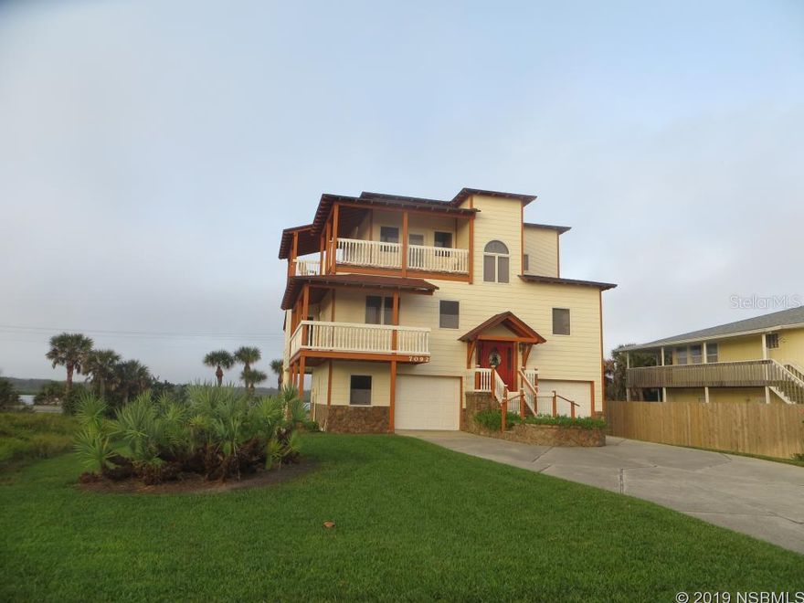 Three separate balconies for spectacular views of the river and ocean.  Public beach walkover to a no driving beach is across the street. Quiet end of the beach near the Canaveral Seashore. Hardwood floors. Large living/dining area with lines to run a propane tank to the fireplace. Living area has half bath. Master suite has private bath with spa tub and separate glass block shower and large closet. Upstairs has two bedrooms with full bath and family room. Plantation shutters. Two separate garages with half bath in between. Lot is 150X75 and expands from S. Atlantic to Turtlemound. Manicured lawn. ;Water: City