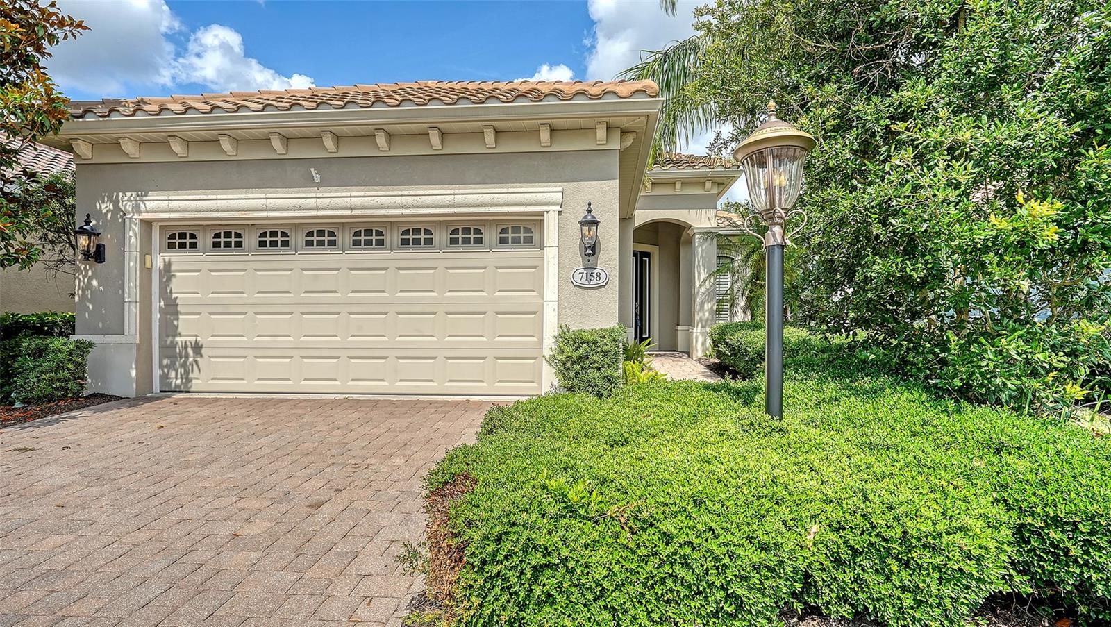 One or more photo(s) has been virtually staged. Experience the ultimate in maintenance-free luxury in Lakewood Ranch Country Club East! Nestled in the heart of Lakewood Ranch, this stunning pool home offers the perfect blend of elegance and easy living within a prestigious gated, golf course community. Boasting 1,989 square feet of thoughtfully designed space, this home features 2 bedrooms, 2 baths, and a versatile den, ideal for a home office or guest suite. Step inside and be captivated by the open-concept design, where disappearing sliding glass doors seamlessly blend indoor and outdoor living. Enjoy your own private oasis, complete with a screened lanai and sparkling heated pool, perfect for entertaining or unwinding in the Florida sunshine. The chef’s kitchen is a dream, showcasing crisp white cabinetry, gleaming granite countertops, a chic subway tile backsplash, a pantry closet, and top-of-the-line stainless steel appliances. A breakfast bar overlooks the inviting casual dinette area, making morning coffee and casual meals a delight. Additional highlights include: brand-new HVAC system for year-round comfort, freshly painted interior, hurricane shutters for peace of mind, elegant plantation shutters throughout, tray ceiling in the great room for a touch of sophistication, large-format tile flooring in formal spaces, and silhouette blinds & stylish valances in the primary suite. Residents of Country Club East enjoy access to various amenities including a community pool in walking distance and The Retreat, an exclusive amenity center offering a resort-style pool, a fitness facility, social spaces, outdoor kitchen, all included in the HOA fees. Membership opportunities are optional and available at the Lakewood Ranch Golf and Country Club that includes 72 holes of world-class golf including expansive practice areas, a state-of-the-art golf academy and fitting center, 3 full-service restaurants and bars with both indoor and outdoor dining, a 20,000 square foot fitness center and a pool complex with 2 resort-style heated pools, 20 tennis courts and 20 pickleball courts. Country Club East is conveniently located near the Mall at UTC, dining, Waterside Place, Lakewood Ranch Medical Center, Sarasota and Tampa airports, and world famous beaches.
