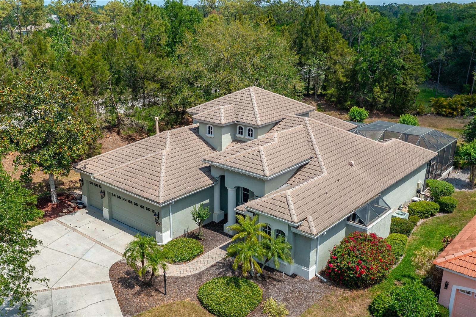 Unfurnished home.Welcome to this beautifully designed 4 bedroom 3 bath home in Lakewood Ranch. When you first arrive, you will be pleased to know that this home is on a very private cul-de-sac featuring mature landscaping, water views, screened pool, and tile roofing. As you enter, you will be greeted by a paved walkway to the pillared entrance through majestic double doors which sets the theme for the rest of the home. Inside, you will be impressed to see hardwood floors, an abundance of light and diamond patterned tile throughout. This estate is a split floor plan, and on the right side of the home is the master bedroom, with tons of natural light, and pool views, the master bedroom also features an excessive amount of closet space for every situation. The Master bathroom itself contains his and her sinks, walk-in shower, tub, and an additional exterior shower. A nursery or office is also on this same side of the estate. This home is fully equipped with gas for the fireplace, outdoor grill and a gas stove that is ready for perfectly cooked meals. Including the gas stove, the kitchen features stainless steel appliances, recessed lights, a kitchen island, beautiful wooden cabinets and looks out onto the living room and pool. The far side of the house contains the rest of the bedrooms, two bathrooms, and the staircase that leads to a bonus room or game room. The pool area itself features brick pavers, hot tub, generously sized pool, and a full-sized outdoor covered kitchen