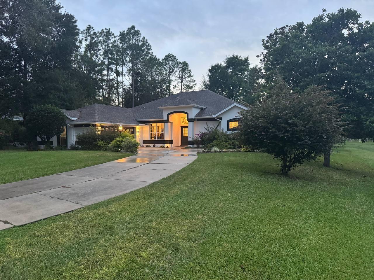 Welcome to 9809 SW 195th Street, Dunnellon, FL — a breathtaking, fully renovated modern estate that perfectly blends high-end style, privacy, and functionality on an oversized double lot. Every inch of this home was upgraded in 2025 with designer finishes, premium materials, and meticulous craftsmanship. Step into the chef’s dream kitchen featuring all-new luxury appliances: 5k CAFÉ refrigerator, 5k CAFÉ range, GE Profile hood, Monogram dishwasher, workstation sink with cup cleaner, and an APEX reverse osmosis water system. Striking black marble-style countertops with five waterfall edges elevate the kitchen into a true showpiece. Retreat to spa-inspired bathrooms showcasing LED mirrors, floating vanities, rainfall showers, and Bosch toilets. The resort-style backyard offers a saltwater pool and heater, surrounded by lush landscaping and 70 newly planted privacy trees for an intimate, serene escape. Additional features include halo dimmable lighting, epoxy-coated garage floors, elegant French doors leading to the outdoor living area, and a modern open-concept design. The home comes fully furnished with over 30k in premium furniture and technology—including a 100” TV, pool table, piano, and more