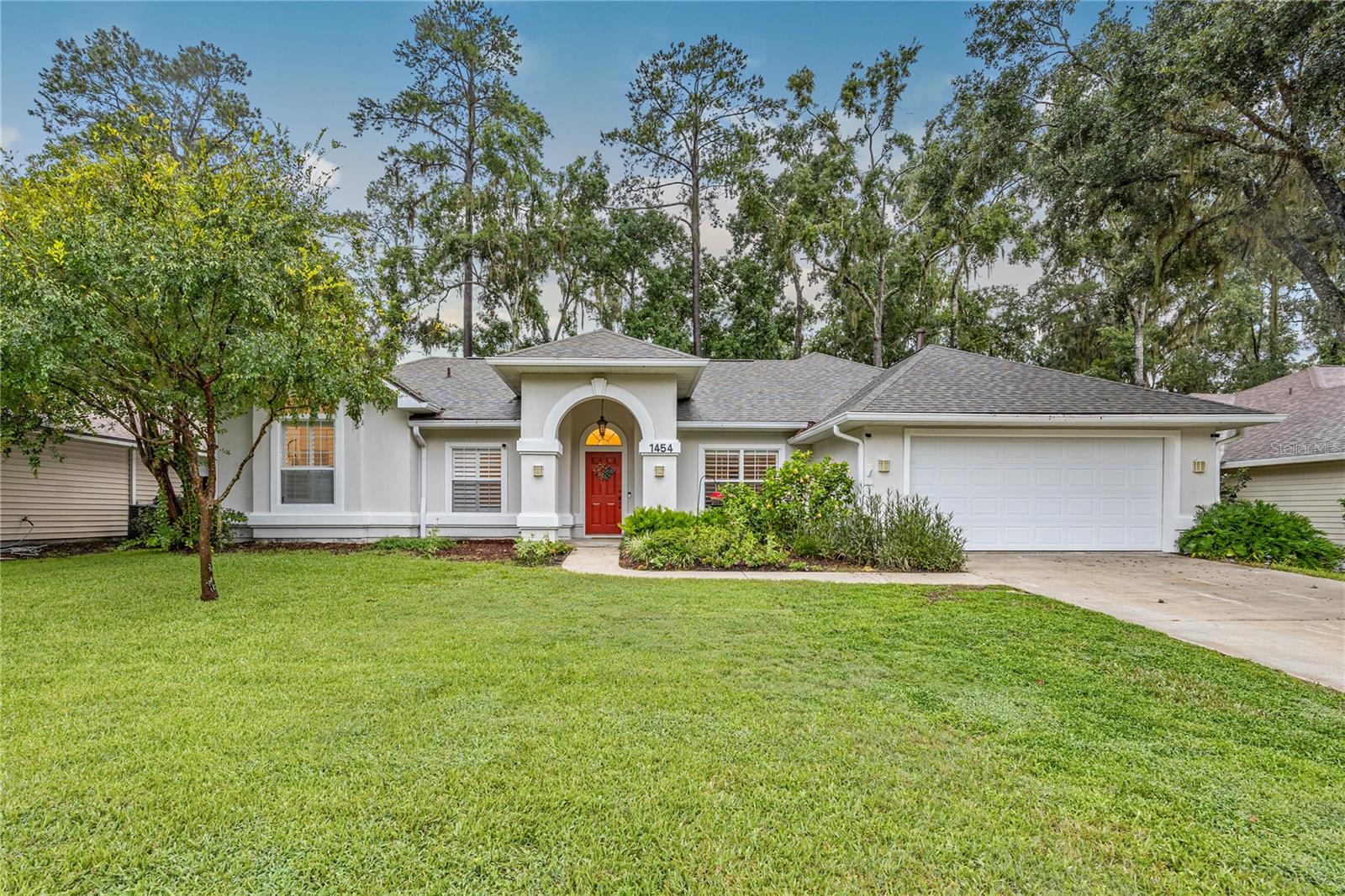 Welcome to this beautifully maintained 4-bedroom, 2-bathroom home offering over 2,000 square feet of living space on nearly a quarter-acre lot in the highly desirable Broadmoor subdivision of Gainesville, Florida. This thoughtfully designed residence features a 3-way split floorplan, vaulted ceilings, and multiple living and dining areas, providing both comfort and functionality for everyday living and entertaining. Engineered hardwood flooring flows through most of the home, while tile enhances the kitchen and bathrooms. The kitchen overlooks the family room and is equipped with stainless steel appliances, updated fixtures, and a breakfast bar, making it the perfect hub for gathering.
The spacious primary suite serves as a private retreat, offering a fully renovated en-suite bathroom that showcases an oversized walk-in shower, dual vanities, and a freestanding soaking tub beneath a large arched window. The guest bathroom is also beautifully updated with modern finishes, maintaining a cohesive and stylish feel throughout the home. Just off the family room, a covered and screened patio opens to an elevated wood deck, ideal for relaxing or entertaining, all while overlooking a large, fully fenced backyard. Major updates include a brand new 2025 HVAC system and a roof replacement in 2022, offering peace of mind and long-term value.
Broadmoor is an established neighborhood known for its community pool and clubhouse. Zoned for top-rated schools including Hidden Oak Elementary, Fort Clarke Middle, and Buchholz High School, the location also offers easy access to shopping and dining at Tioga Town Center, Publix, and the Oaks Mall. Proximity to the University of Florida, Shands Hospital, and North Florida Regional Medical Center makes this home an excellent choice for families and professionals alike. This move-in-ready property combines quality finishes, a functional layout, and a prime location—don’t miss your opportunity to call it home.