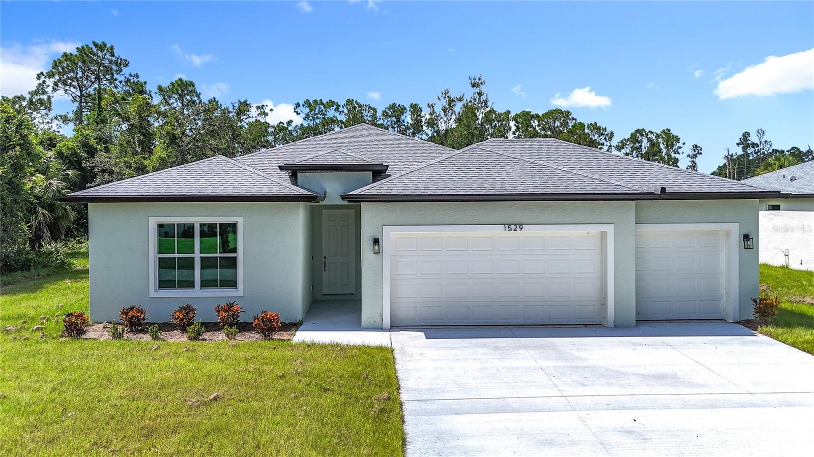 NEW CONSTRUCTION - Completed, move-in ready! This concrete block 4-bedroom 3-bathroom 3 car garage home boast a modern
design with high ceilings and features an open spacious floorplan design. With an awesome gourmet-inspired kitchen that features white
cabinets with a large center island and subway backsplash and upgrades that include Stainless-steel Samsung appliance package with washer
and dryer. Luxury wood-vinyl flooring throughout the common areas. A spacious master bedroom with tray ceilings, two walk-in closets, a
private bathroom with dual vanity area, and large open walk-in shower. Front bedroom with bathroom is perfect for a guest room, mother in-law suite, or office. Home also features indoor laundry room connecting the attached garage, water softener, double pane windows, and sliding glass door that lead out to the open lanai. This brand new home is a must see