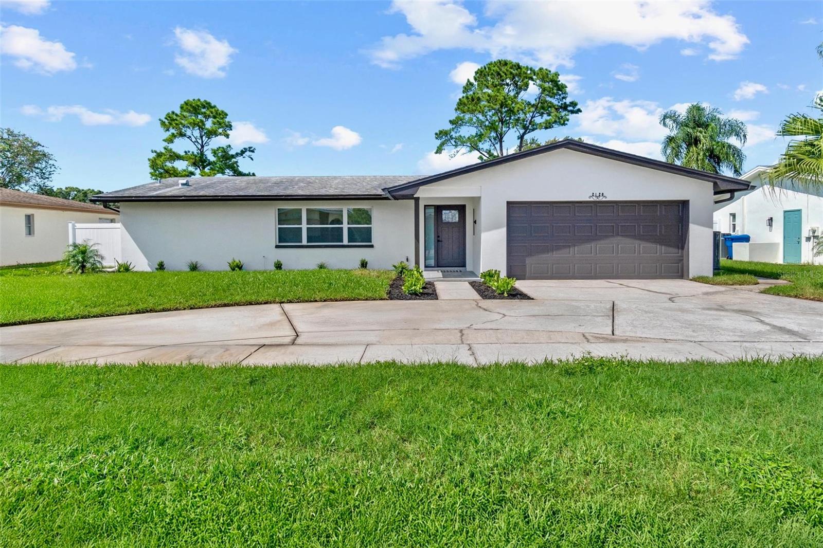 Modern Pool Home – Fully Updated & Move-In Ready! This beautifully renovated 4-bedroom, 2-bath residence offers an open floor plan with a brand new kitchen featuring quartz countertops, new stainless steel appliances, and modern cabinetry, along with fully remodeled bathrooms. Fresh interior and exterior paint, waterproof pet-friendly flooring, new doors, impact windows and sliding doors, updated lighting, and fixtures provide a stylish and functional upgrade throughout. Outdoors, enjoy a sparkling screened-in pool, landscaped yard with full sprinkler system, and attached two-car garage. Conveniently located near shopping, dining, and stunning beaches—move-in ready and a must-see!