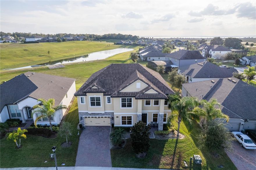 This stunning 5-bedroom, 4.5-bath residence in the gated community of Vistas at Waters Edge offers exceptional space, comfort, and style. Built in 2020 and beautifully maintained, this home features 4,850 sq ft of living living area and stands as one of the largest homes in the neighborhood, offering a layout designed for both everyday living and memorable entertaining. The first floor showcases sleek epoxy flooring that creates a modern, seamless flow through the main living spaces, while the spacious kitchen opens effortlessly into the family room, making it ideal for gatherings. Upstairs, you’ll find a true retreat with a large common room complete with a built-in sink and counter, perfect for a coffee bar, snack area, homework lounge, or secondary living space. The dedicated theater-style room provides an impressive setting for movie nights, gaming, or a private media lounge. The luxurious primary suite includes a generous walk-in closet and an elegant master bathroom designed for comfort and privacy. Additional bedrooms feature reach-in closets and comfortable carpeting for a warm, welcoming feel. With a 5-year-old roof, 5-year-old HVAC system, dedicated laundry room, and low-maintenance finishes throughout, this home offers peace of mind and convenience. Located in a secure, well-kept gated community with an HOA of just $125/month, the neighborhood is minutes from Lake Apopka, parks, shopping, dining, and major roadways. This is an exceptional opportunity to own a move-in-ready home with standout features in one of Apopka’s most desirable communities.