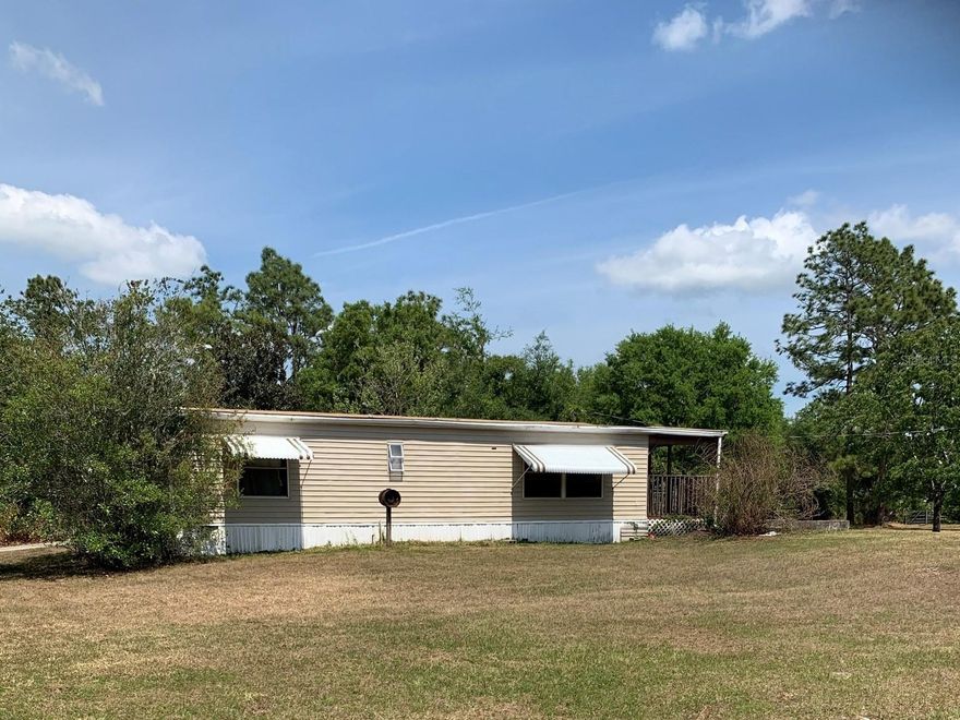 2/2 Mobile home on 2 acres in Holopaw, fenced, Screened porch + side porch, Stove, Refrigerator, CHA, Shed, W/D hook-up, separate laundry room off screened porch.