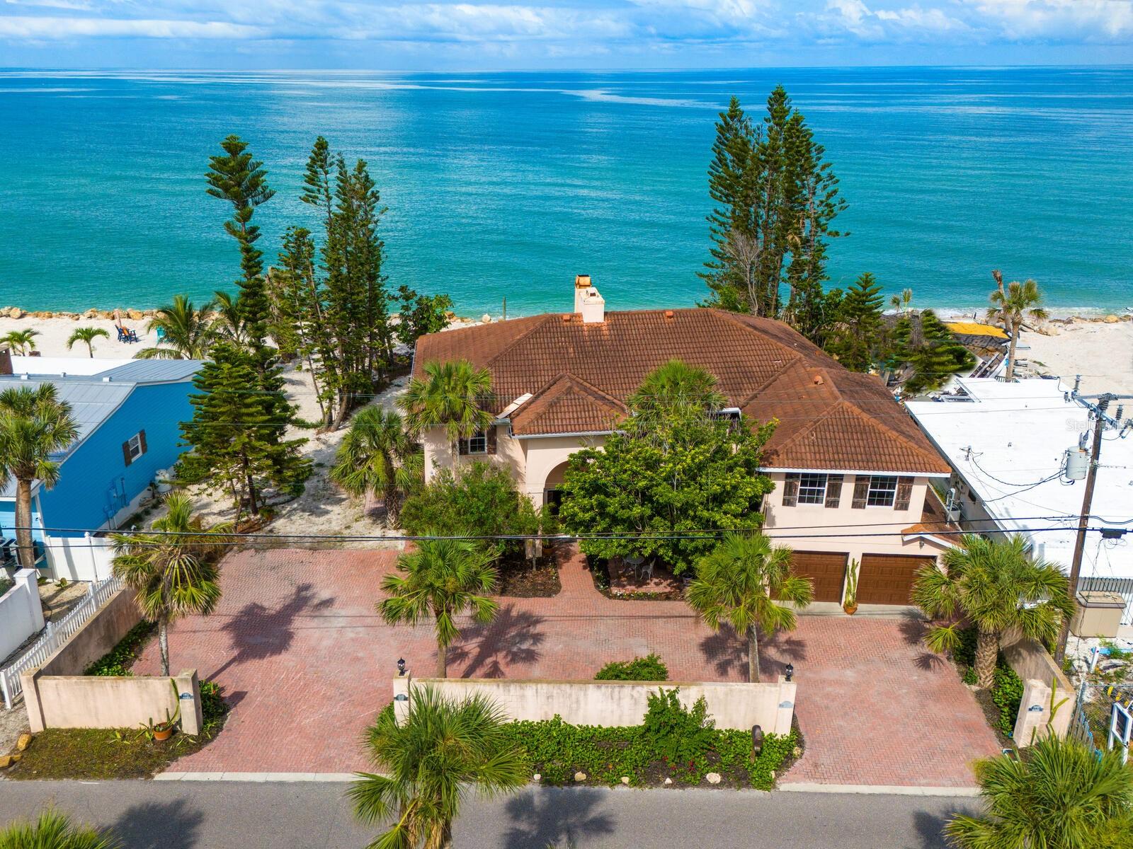 One or more photo(s) has been virtually staged. Classic Gulf-Front Living on Casey Key — Priced at Land Value. Wake up to the soothing sound of waves in this classic Gulf-front property, perfectly positioned along the shoreline of Casey Key. With nearly 100 feet of direct Gulf frontage on almost half an acre, this home provides panoramic views of the sparkling Gulf and the unique chance to enjoy beachfront living now, while planning for the future. Resilient through recent storms, the existing home is livable and full of charm—ideal for immediate use, thoughtful renovation, or redevelopment into your dream coastal retreat. The first floor features a main kitchen, living room, home office, and two guest suites, while the entire second floor is dedicated to an expansive owner’s suite with a kitchenette and dual full bathrooms. A private-entry guest suite adds flexibility for hosting extended family or visitors in comfort. A grandfathered-in rock revetment along the shoreline offers rare and valuable storm protection, enhancing the property's long-term security and investment potential. Located near the Blackburn Point Bridge, you'll enjoy easy on-and-off access to the mainland, all while savoring the secluded tranquility that defines Casey Key. Enjoy nearby favorites like the Casey Key Fish House & Tiki Bar, Pop’s Sunset Grill and Deep Lagoon Restaurant—or explore the cultural offerings of downtown Sarasota and Venice, just a short drive away. Daily essentials are conveniently close with the Publix Shopping Center and Tamiami Trail just a mile from your doorstep. Whether you're seeking a serene beach escape, a high-potential building lot, or a legacy investment, this Gulf-front gem offers the best of all worlds: location, protection, and unmatched possibility.