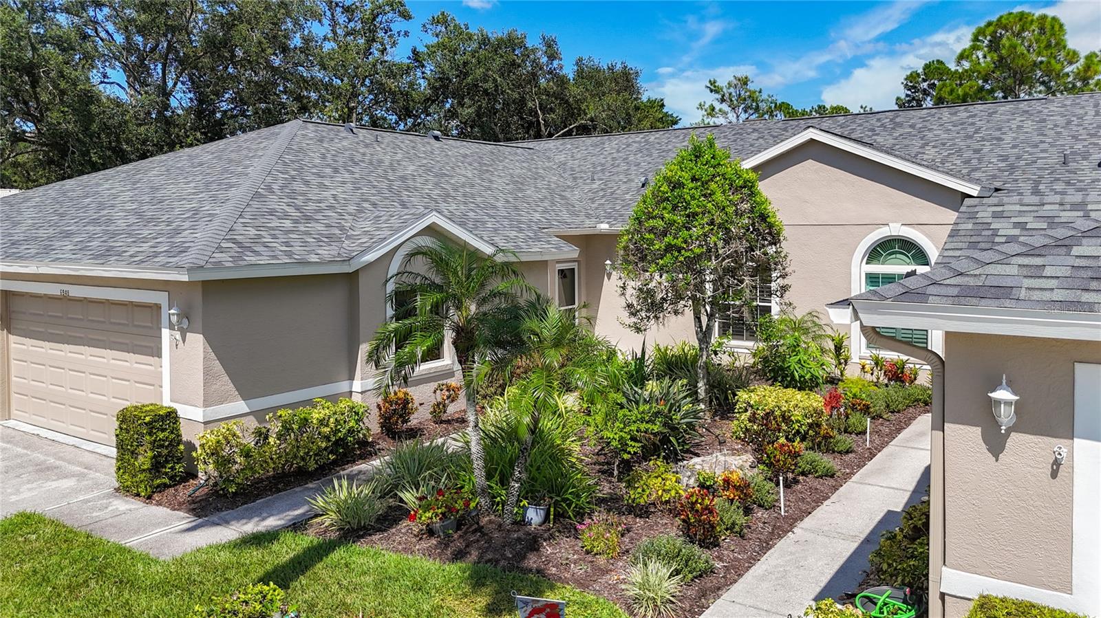 One or more photo(s) has been virtually staged. Your Florida Country Club lifestyle awaits at this Tara Golf and Country Club Villa. Tara is a private member only club. This updated villa includes a deeded Class ’A’ equity golf membership that transfers to the new owner. On the 8th tee boxes you enjoy views of natural Florida tropical greenery while being entertained by watching the golfers as they tee off. The Villas exterior is recently updated with a new roof in 2023, exterior paint 2022, new community pool pump and heater, irrigation system and more. Plus, the villa’s interior has updated flooring, crown molding, shutters, and the kitchen features extra built in storage, granite counters, and spacious eat-in sunny and bright space. This spacious 2 bedroom plus Den, 2 updated bathrooms, 2 car attached garage with new hurricane rated garage door 2021. The lanai bonus room has impact sliding doors updated 2015 and can also have a 12’x15’ screened lanai added to the patio to further enhance your outdoor enjoyment. A Class "A" equity golf membership accompanies this villa with an abundance of amenities including Tara's Championship 18 hole Golf Course, Har-Tru tennis courts, pickle ball plus a new 5 court pickle ball center is under construction and will be ready for play in late 2025. The country club facilities include a Fitness Center with state of the art equipment, hot tub, sauna. The Clubhouse features bar and casual grill room, fine dining, with additional screened patio for outdoor dining. A concession stand at the main clubhouse pool is conveniently located on the turn-around between the 9th and 10th holes. The driving range, short game practice area, putting green, and pro-shop form the hub of daily golf activity. Tara offers something for everyone with a very active social and entertainment calendar. Mandatory fees for full golf membership are $526.56 monthly plus $60.00 food minimum. A one-time Capital Contribution fee of $5000.00 is payable at closing. Quarterly condo association fees for exterior maintenance free living are $1200.00. The Tara Master Association annual fee is $1094.17 that includes Comcast premium bundle for internet and cable TV plus HBO/MAX. This annual fee also includes maintenance of the common area landscaping and the perimeter maintenance of the common grounds. Easy access to I-75, airports, great shopping and UTC mall, arts, theater, entertainment, dining, and the award winning beaches on the Suncoast of Florida. Make The Villas at Tara Golf & Country Club your Florida lifestyle!