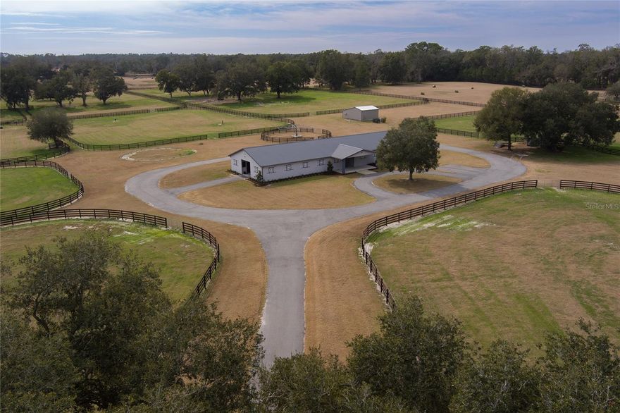 Less than 8 minutes to the World Equestrian Center, and located in the Farmland Preservation Area! This approximately 30 acre farm is nestled in the heart of NW Ocala's esteemed horse country and features under-utilized lush pastures liberally dotted with mature shade trees, and surrounded by beautifully-maintained four board fencing. The spotless 15-stall, center-aisle barn features an indoor wash rack with hot and cold water, tack room, and bathroom. There is a studio apartment with its own bathroom, kitchen, and mini-split air conditioning/heat unit; there is also a utility room with fridge, washer and dryer, and storage. A large 3-bay storage/shop building provides plenty of safe storage for feed, hay, tools, and farm equipment. There is also a loading station and a hot walker. Additional acreage available.