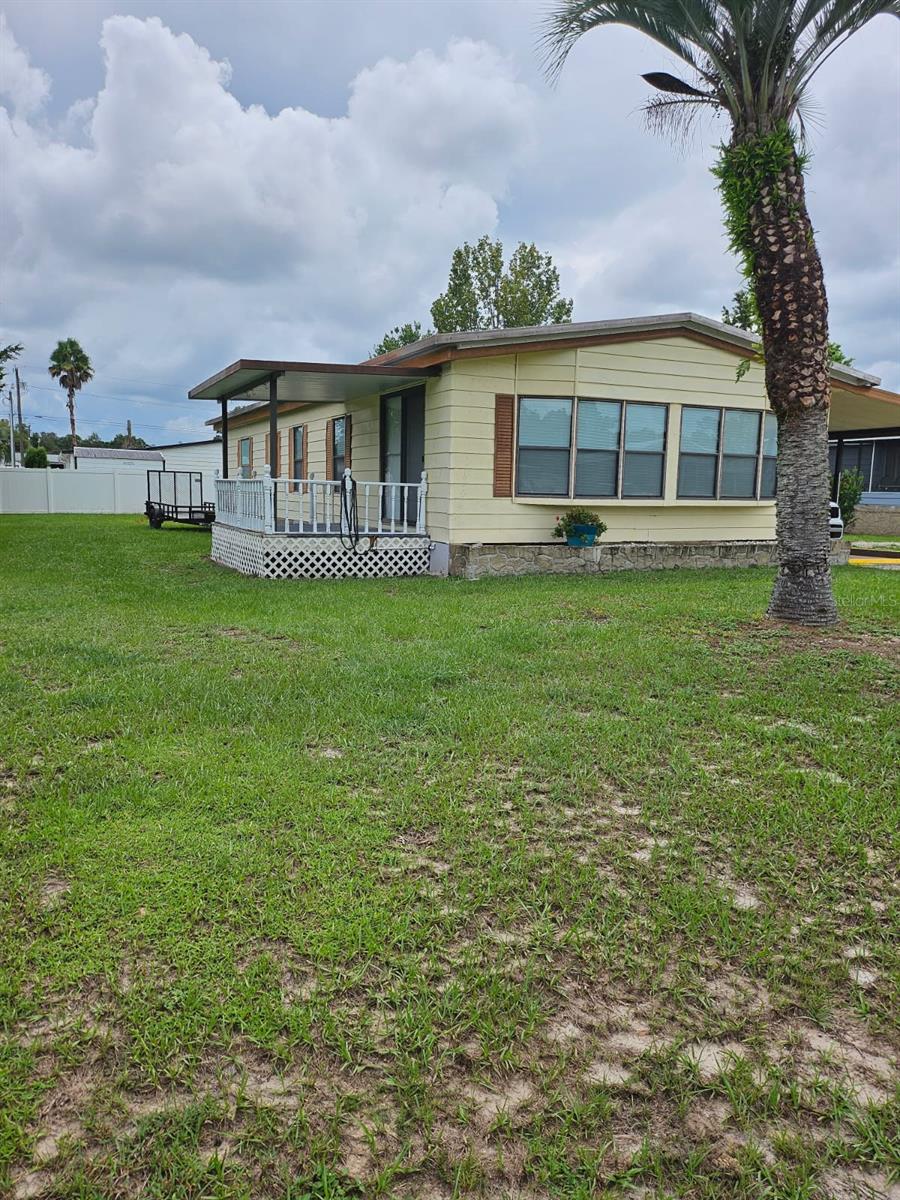 This move-in ready 2-bedroom, 2-bath home features an open layout with stone countertops, new cabinets, and updated tile in the bathrooms. Enjoy fresh carpet in the bedrooms, a screened lanai with vinyl windows, and peace of mind with a 2017 metal roof, 2016 A/C, and newer water heater. Nestled in a quiet neighborhood just minutes from downtown Ocala and right behind Silver Springs State Park — with no lot rent — this home offers comfort, convenience, and value all in one!