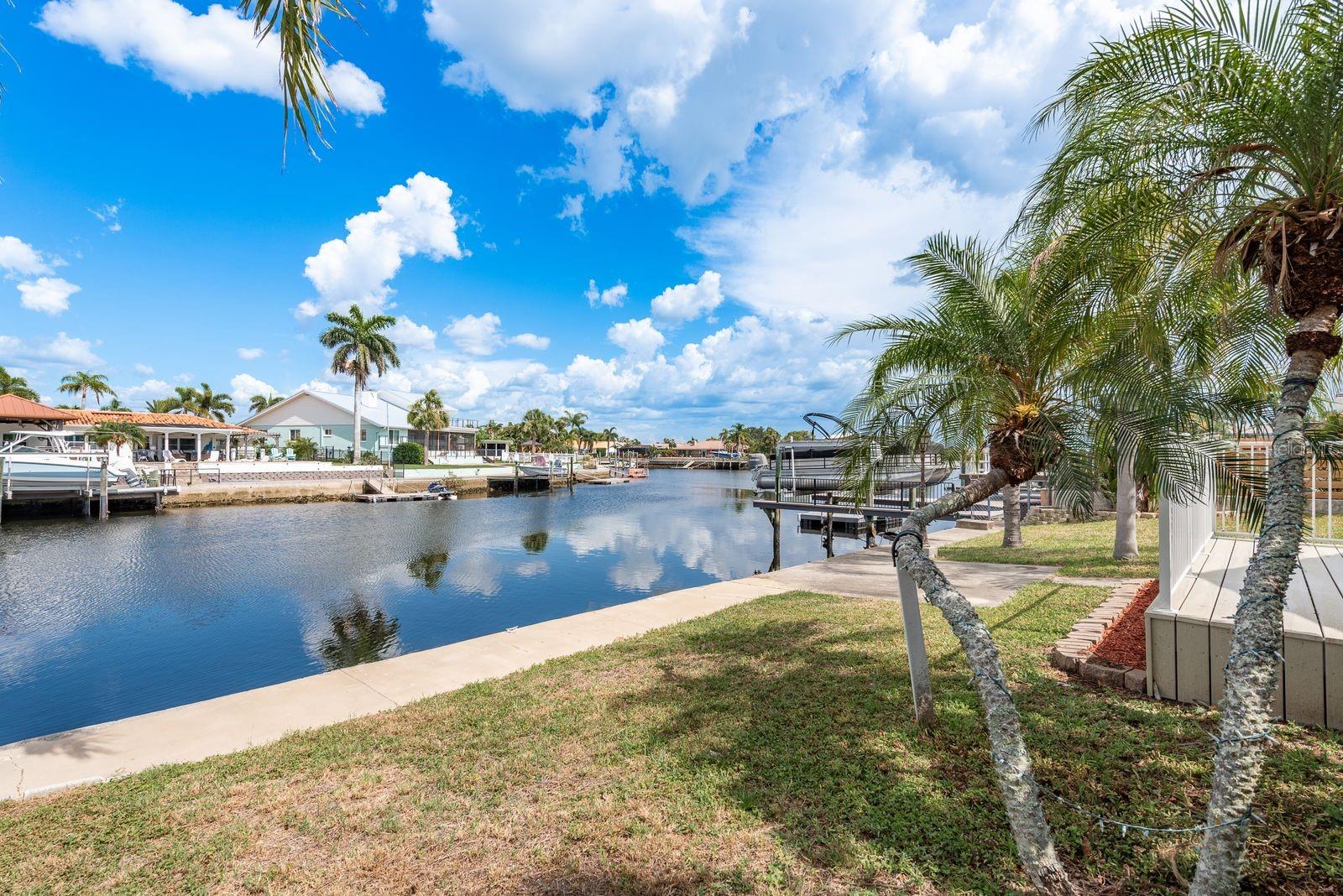 Come enjoy the warm & tropical Florida waterfront lifestyle in this spacious 2-bed, 2-bath, 2-car garage home with 1,839 square feet if heated and cooled living space located in the highly sought-after community of Gulf Harbors. This renovated home is situated on a large lot with 66 feet of seawall that has deep sailboat friendly water and provides quick, easy, and unobstructed access to the open waters of the Gulf of Mexico and is ready for you & your boat(s) to start enjoying the sandy beaches of nearby tropical islands! This home has a wonderful split-bedroom floor plan with a large living and dining room combo, opening to an expansive 27’ x 12’ family room with spectacular water views! Beautiful newly installed vinal laminate flooring throughout most of the home. The Kitchen boasts new white shaker cabinets, quartz countertops, and a large 13’ X 14’ eat in space overlooking the waterfront. Large primary suite with French doors leading into the family room, walk-in closet and private bath with step-in shower. The guest bedroom is very gracious in size and is serviced by the guest bath. Entertain guests on the large composite deck overlooking the waterfront. Gulf Harbors has an optional association that offers 2 boat launches & other amenities. You also have the option to join the Gulf Harbors members-only private sandy beach just a short bike ride away that offers cabanas & grills and overlooks the Gulf of Mexico and Anclote Key. Downtown New Port Richey, just a short drive away is lively and quaint with many restaurants, bars, shops, and Sims Park where you can enjoy one of the many special events and outdoor concerts throughout the year or stroll along the beautiful riverwalk along the Cottee River. Call to schedule your viewing today!