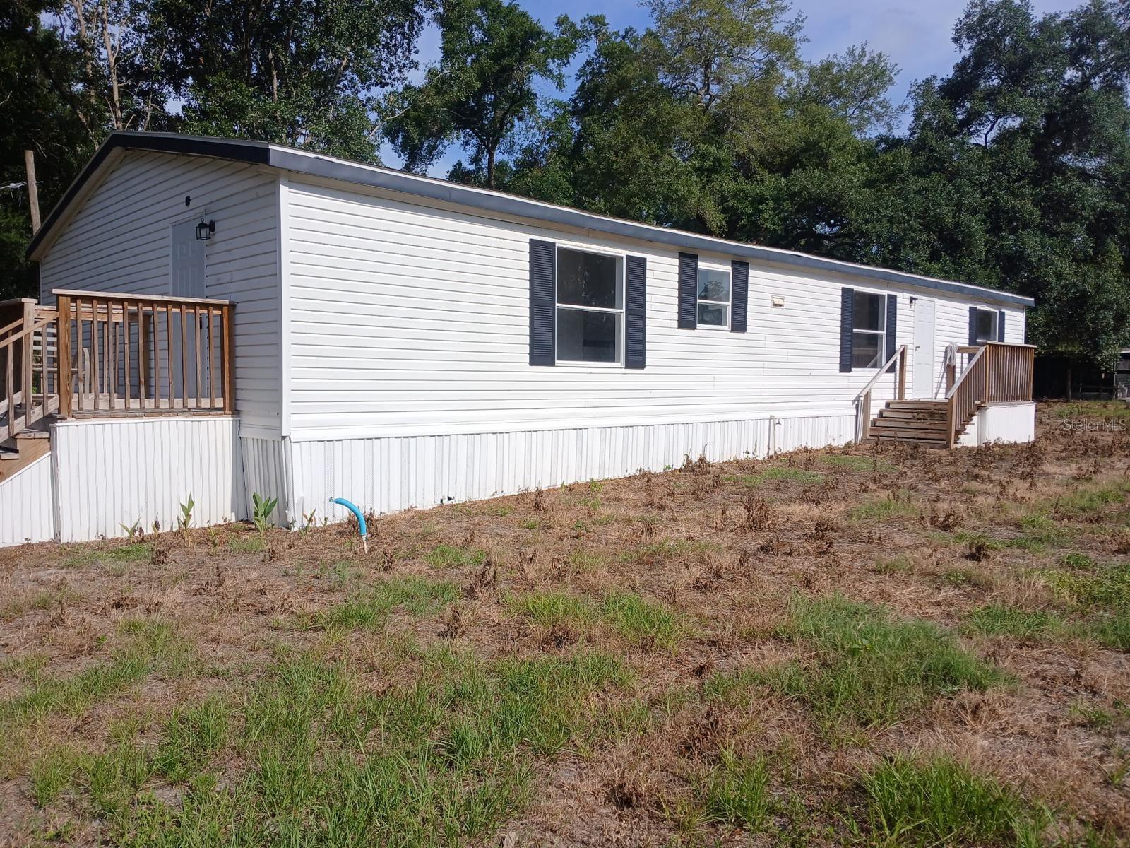Why Rent When You Could Own THIS? Move-in Ready & Priced to Sell!
Stop throwing money away on rent and step into homeownership with this fully renovated 3 bedroom, 2 bath manufactured home—and yes, you OWN the land! No lot rent headaches here.
This home is packed with upgrades to make your life easy:
Fresh interior paint throughout
Brand new HVAC system (stay cool, stay efficient)
Brand new stainless steel kitchen appliances (on order, yours soon!)
New smoke detectors—you get to pull the tab yourself and break them in!
Tucked away on a quiet side street just west of US 301, this home offers peace of mind and convenience. With the brand new Wildwood Police Station just around the corner, you’ll sleep easy knowing safety is close by.
Ideal as a first home, commuter hub, or investment—walk or bike to local Wildwood shopping, and access The Villages in three different directions. If you work in or around The Villages, this location cuts your commute and keeps more time in your day.
Here’s the deal—affordable homes with real land ownership under $200,000 don’t sit long, especially if the buyer may qualify for special financing through one of our lending partners.
Schedule your private tour today… because deals like this don’t wait, and neither should you!