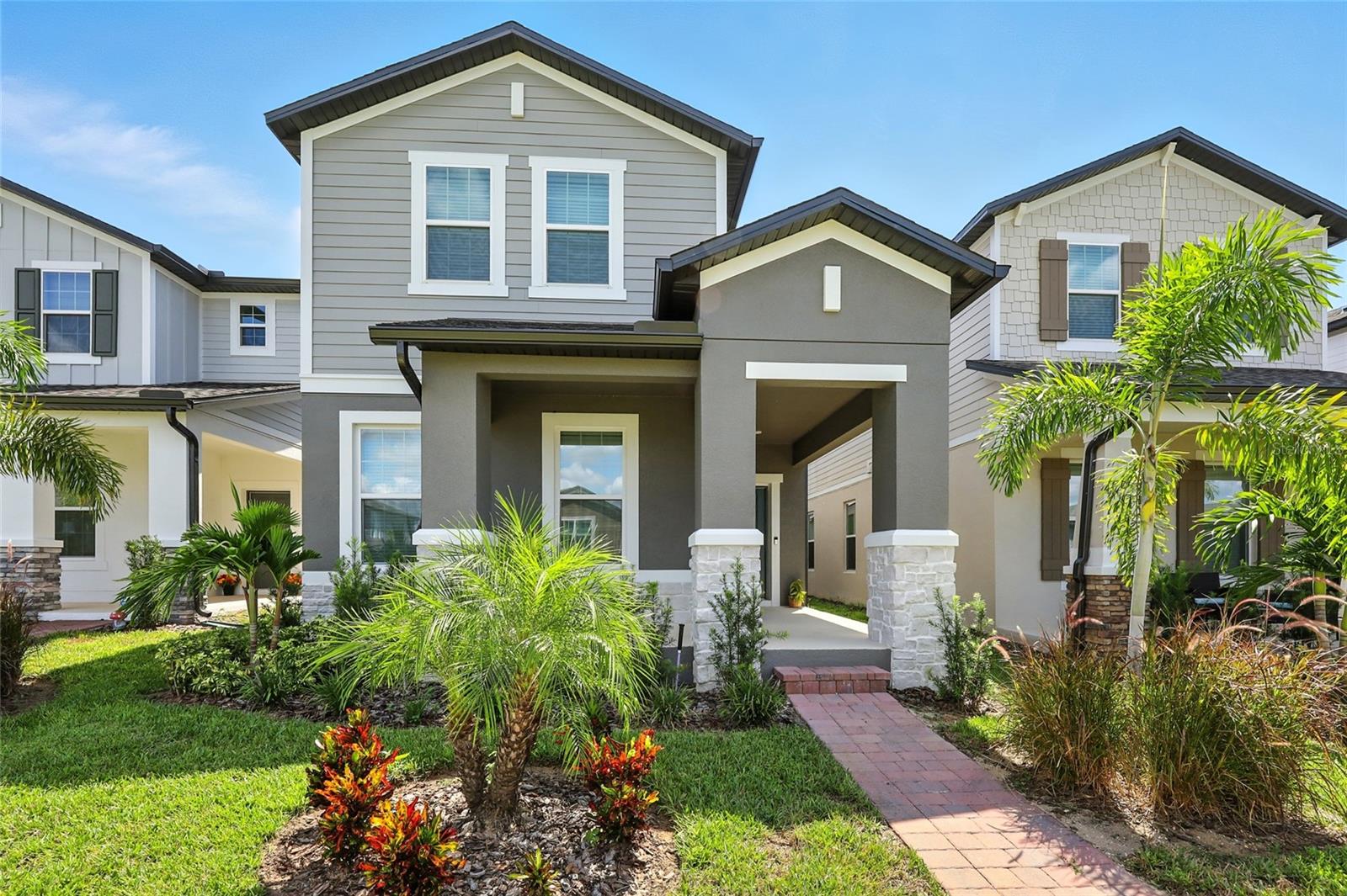 Move-in ready and nearly new, this beautifully upgraded Wekiva floor plan offers a thoughtfully designed layout with a guest suite on the first floor, an open-concept family, dining, and kitchen area, plus inviting outdoor spaces including a large wraparound front porch and a covered lanai. The owner’s suite features two spacious walk-in closets, a frameless glass shower, a stand-alone tub, and dual sinks, while the upstairs loft provides additional living space for entertainment or work-from-home needs. Elegant finishes throughout include wood-look tile flooring, a gourmet kitchen with cooktop and double ovens, quartz countertops, and 42-inch painted linen cabinets. Located in the highly desirable Encore at Ovation community, just 4 miles from Disney, this home offers unmatched convenience with quick access to SR-429, US-192, World Drive, I-4, and SR-417, connecting you easily to Orlando’s top attractions, dining, and major employment centers.