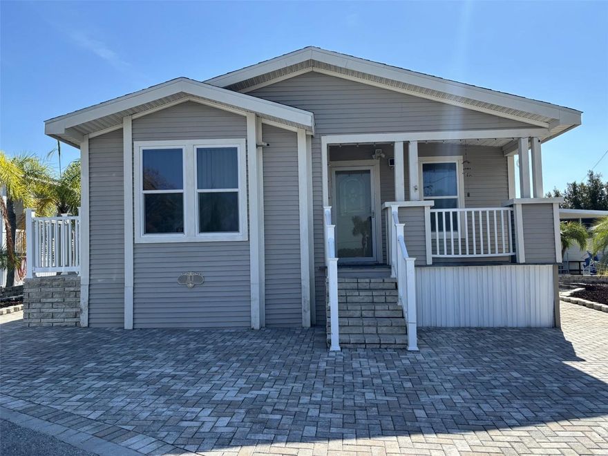 Beautifully updated home in the 55+ gated West View Ridge community! This home is located in a community where you own your land. This move-in-ready property offers great curb appeal with a paver driveway/walkway, tropical landscaping and a cozy front porch. Inside, enjoy new vinyl flooring, a 2-year -old AC, a bright living room with tall windows and a spacious kitchen with plenty of cabinet storage. This home also has a central vacuum system.  The large primary bathroom features a walk-in glass shower, soaking tub and dual vanities. Home also includes an indoor laundry room, a storage shed and low-maintenance yard design. Located minutes from Hwy 27, shopping, restaurants, medical centers and a short drive to Orlando attractions. Community amenities include a clubhouse, pool, activities and secure gated entry. Perfect for low maintenance retirement living or seasonal use.