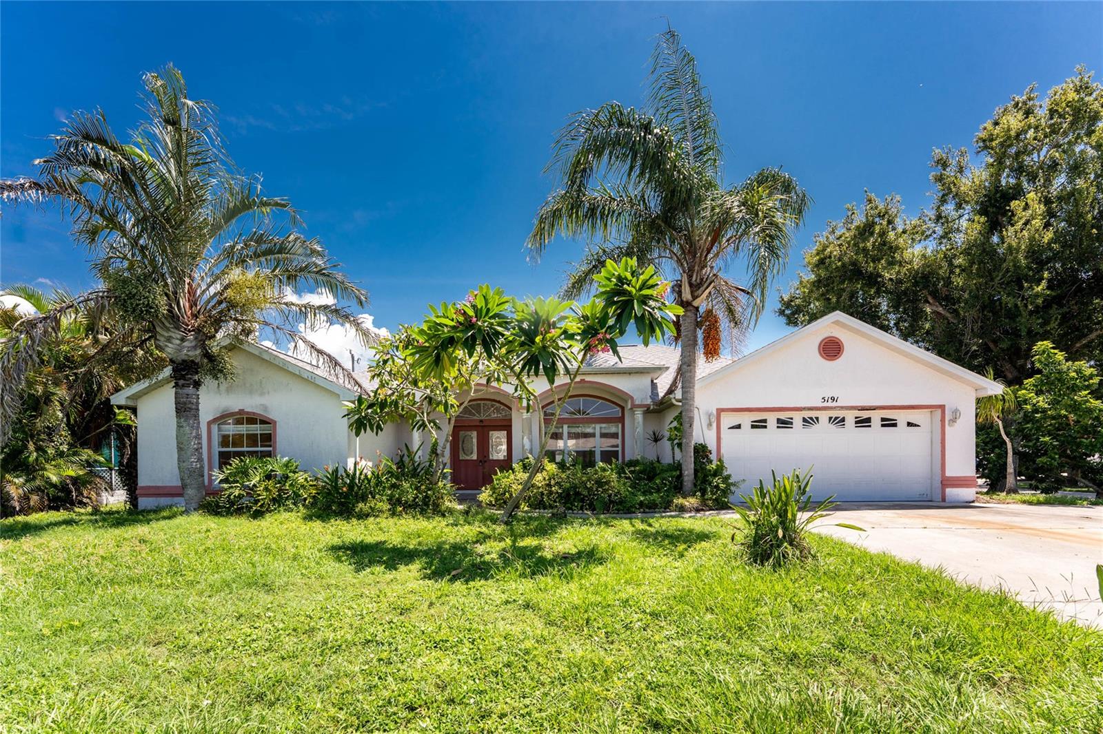 Discover the possibilities in this South Venice home with optional beach ferry and boat ramp access! This 3 bedroom, 2.5 bath home with a 2 car garage and oversized driveway is located on a triple lot in the X-flood zone and features a 2024 roof and A/C, giving you peace of mind knowing major updates are already complete. Double front doors with a transom window welcome you inside to explore the open layout and the potential this home has to offer. Vaulted ceilings and chandeliers in the foyer and formal dining area, along with a tiered tray ceiling in the great room, provide extra charm. Tile floors throughout the main living areas make maintenance easy, and a large set of sliding glass doors expands the living space to the outdoors. The kitchen is spacious with plenty of cabinets, a large breakfast bar, built-in desk, walk-in pantry, and a bright aquarium window with room for a breakfast table overlooking the backyard. Just off the kitchen, the family room provides another gathering space with sliding doors to the lanai, creating a comfortable spot to cook, entertain, and connect with family and friends. The ensuite master bedroom is ready for your choice of flooring to complete the space and includes two walk-in closets and a tray ceiling. The master bathroom features tile flooring, a relaxing Jacuzzi tub set beneath a large window where you can enjoy natural light and peaceful views, an oversized dual sink vanity, and a walk-in shower. The two guest bedrooms also include tray ceilings and reach-in closets, with one finished in tile flooring and the other in laminate wood flooring. The guest bathroom is well equipped with a large single sink vanity and a tub-shower combination. The interior laundry room is both practical and convenient, offering built-in cabinets for storage along with a utility sink to make daily chores easier. Step outside to the expansive caged and tiled lanai, surrounded by privacy fencing and ready for new screening to make it your own. This oversized outdoor area is perfect for creating your ideal Florida living space, with plenty of room for dining and lounge furniture or even the addition of a hot tub to relax under the stars. This home is located in a wonderful community where you can join the South Venice Beach Endowment Trust, offering access to a private boat ramp, kayak and canoe launch, paddleboarding, and a community ferry that carries you across the bay to a private beach. Beyond the neighborhood, you’ll love being just minutes from the charm of Historic Venice Island with its boutique shops, restaurants, year-round events, and weekly farmers markets. Venice is also known for its miles of sandy Gulf beaches, including Caspersen Beach, famous for shark tooth hunting. For even more dining, shopping, and entertainment, the all-new Wellen Park is a short drive away and features waterfront restaurants, live music, community events, and the Atlanta Braves Spring Training Stadium. This home at 5191 Pompano Road combines relaxed coastal living with access to all of Venice’s most popular attractions. Don’t miss your chance, contact us to schedule a private showing today.