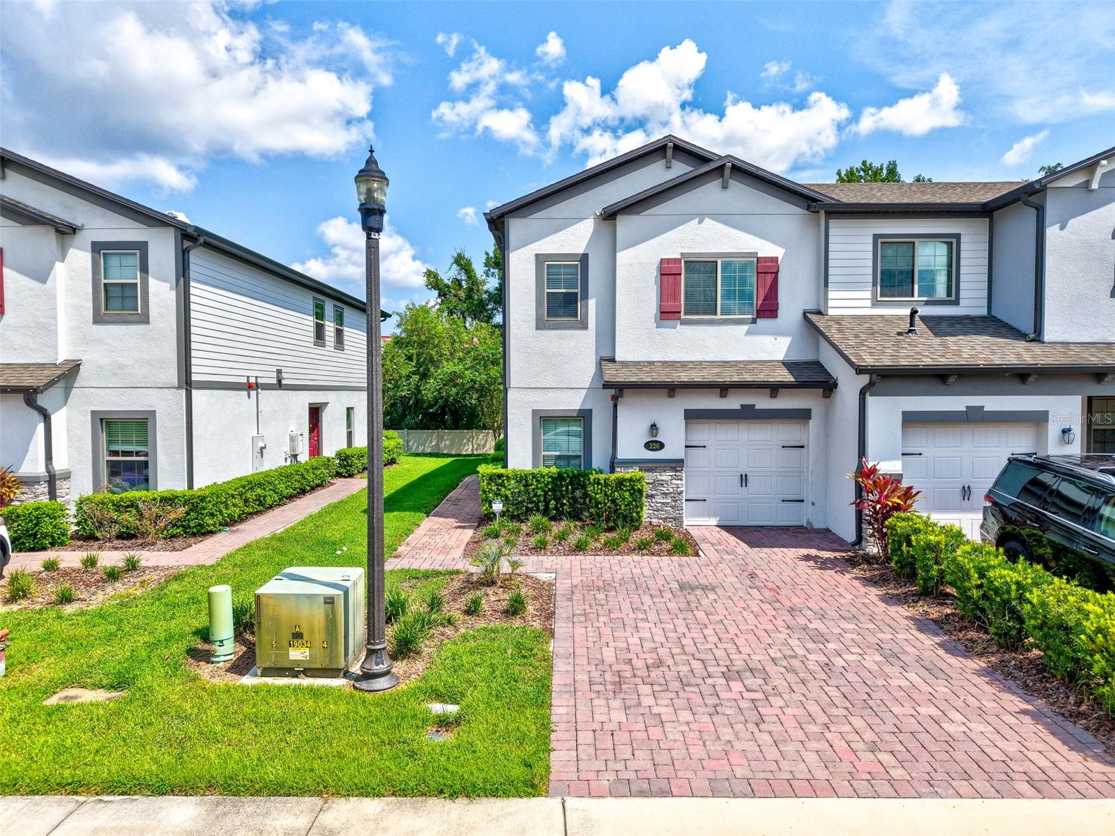 Stunning End-Unit Townhome – Former Model with Upgrades Throughout!
This beautifully designed 1,745 sq. ft. end-unit townhome (former model home) offers 4 bedrooms, 3 full baths, a 1-car garage, and a 2-car wide brick-paved driveway. Its end-unit placement provides extra privacy, additional outdoor living space, and the feel of a single-family home.
Inside, the open-concept floorplan seamlessly connects the kitchen, dining, and great room. Stylish floating shelves around the TV create a clean, modern look, while a feature trim wall and statement light fixtures—including sconces and a chandelier—add sophistication to the dining area, which comfortably seats six.
The chef’s kitchen is a true highlight, featuring granite countertops, a center island with sink and seating, 42” linen cabinetry, subway tile backsplash, and a full suite of GE® stainless steel appliances including a gas range. The screened-in patio extends your living space, perfect for relaxing or entertaining year-round.
The first floor also offers a versatile bedroom and full bath, along with wood-look tile flooring for easy care and style. Upstairs, a spacious loft, laundry room, and linen closet provide convenience, while two secondary bedrooms and a hall bath sit toward the back. At the front, the owner’s suite impresses with a massive walk-in closet and a spa-like en-suite featuring dual sinks, a large walk-in shower with subway tile, and plenty of storage.
This rare opportunity to own a model-quality home with thoughtful upgrades in a prime location won’t last long. Schedule your private showing today!