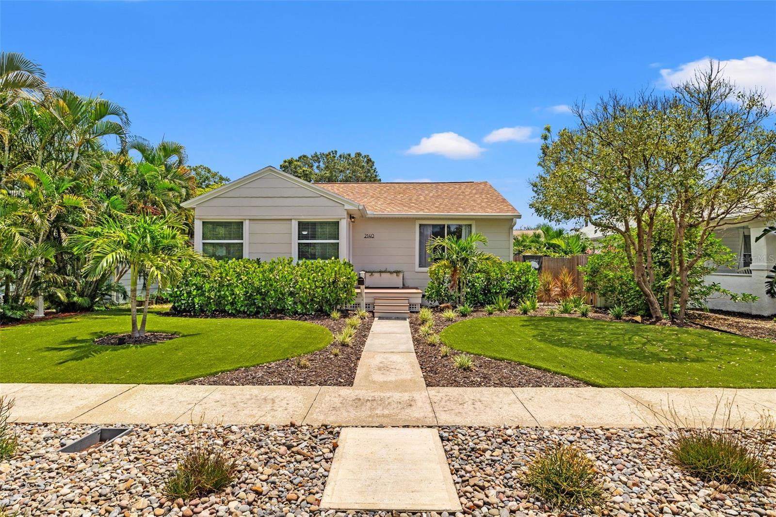 Welcome to 2140 4th Ave N, a beautifully updated bungalow in the heart of Historic Kenwood. This 4-bedroom, 1.5-bath home has been thoughtfully upgraded from top to bottom and sits high and dry in a non-evacuation zone on a charming street in one of St. Pete’s most walkable and inclusive neighborhoods. Inside, you'll find fresh interior (and exterior) paint, new LifeProof™ LVP flooring (2024), new baseboards, crown molding, a built-in breakfast nook, plantation blinds, and a bright, open layout that feels instantly inviting. The kitchen features granite countertops, stainless steel appliances (including induction cooktop), and a custom pantry. The home features a fully remodeled main bathroom and an updated half bath, perfect for guests. Plus, the finished garage offers an additional 240 sqft for a creative flex room or home gym and features a new insulated garage door (2024). Step outside and enjoy low-maintenance, eco-friendly landscaping with over 725 sqft of premium SYNLAWN® SYNAugustine turf (2022) in the front and a blank canvas back yard ready to become your dream outdoor oasis. Upgrades include newer fencing (vinyl 2021/2022, wood 2022), and TimberTech® composite decking in both the front and back (2024). Enjoy peace of mind knowing big-ticket items have been handled: shingle roof (2022), flat rolled roof (2024), full ductwork replacement (2023), 80-gallon water heater (2022), upgraded electrical panel with grounded GFCI outlets (2022), and smart Google Nest thermostat. Washer/dryer, garage floor mats, and front porch planter convey. All of this just blocks from Central Ave, minutes to downtown, and a short drive to the beach. This is the kind of home that makes moving easy; everything’s already been done so you can just move right in and enjoy all Kenwood has to offer!