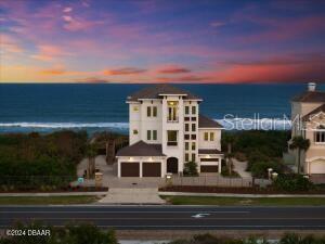 Unicorn Alert! Offered for sale for the very first time is this newly constructed (2023) custom built 4 bedroom, 4 bath, 3 car garage direct oceanfront home in Hammock Dunes Clusters. As you approach the pavered driveway, you will find coquina stone and wrought iron fences creating an elegant buffer from A1A. The home has two separate garages which in total, hold three vehicles. Double doors open to a large receiving foyer complete with elevator and access doors to both conditioned and unconditioned storage areas. Ascend the stairs with hardwood handrails to the second floor and be greeted with jaw-dropping views of the beach and Atlantic coastline. The great room has a linear glass fireplace, beam-in-tray ceiling and three 8' x 4' windows that flood the home with natural sunlight. The open floor plan flows seamlessly into the kitchen & dining room that together, combine to create an off-the-charts ''WOW FACTOR!'' The kitchen features a center island with farm sink, a custom hood
above a five burner glass cooktop, a built-in oven and microwave, dishwasher, beverage cooler and upper cabinets that extend to the ceiling to maximize storage. Tucked neatly into one corner is a door to the separate butlers kitchen containing open shelving, base cabinets with soft-close drawers, pantry, second sink and dishwasher. The dining room contains a built-in window seat with additional storage and glass doors that open out onto the covered oceanfront balcony. Completing the remainder of the second floor are two sizable guest bedrooms which share a full bathroom with tub/shower combination, a sitting area with granite-topped beverage station, huge laundry room with sink and ample cabinets, and finally, a half bathroom with pedestal sink. Elegant touches include plantation shutters on every non-oceanfront window. The third and top-most floor can be reached via elevator or hardwood stairs featuring wood and wrought iron balustrades. The primary suite, accessed via solid French doors, features a second, linear glass fireplace in a private sitting room, walk-in closet, cathedral ceilings with beams and sliding glass doors that open onto the second covered oceanfront balcony. The primary bathroom features a built-in makeup vanity, dual sinks, a corner glassed-in spa shower with bench and a separate soaking tub. This floor is also home to a fourth bedroom featuring an ensuite bathroom with walk-in glass shower. Exit the elevator landing/sitting area to your private sunset balcony. Whether you wish to sit on one of the many balconies to watch the rolling surf, or jump on your surf board to head out into the water via your private dunewalk, this home calls to all lovers of a sun & sea lifestyle.
This home is also available for possible annual or seasonal lease.
