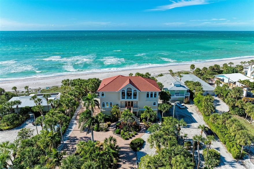 BFE significantly reduced and improved to 10' from prior 13' with recent FEMA changes. The lowest ground floor elevation (garage) is at 12.7'. Remarkable beachfront residence and a $500,000 price improvement. Look out at the sparkling waters of the Gulf and 118' of wide, sandy beach. This custom home was designed with views in mind, boasting panoramic vistas of the Gulf from every room. From calm morning sunrises over the Bay to spectacular and unforgettable sunsets on the Gulf, and watching dolphins, tarpon, and rays play throughout the day, this is a water lover's dream home. Positioned on a pristine stretch of Manasota Key Beach, where the beach has expanded since the home was built, this private estate was built solid and high, including 3 levels and an elevator. The spacious and open top floor offers water views from every window and was set up as the owner's retreat with entertaining in mind. It features a newly remodeled chef's kitchen with beautiful two-tone custom cabinets, modern Quartz countertops, and high-end appliances with 2 built-in ovens, a built-in microwave, and a large center island. The kitchen opens to a great room with vaulted ceilings, tall windows, and a large balcony, allowing for al fresco dining with views of the sparkling Gulf waters. The formal dining room is located towards the front of the home and has spectacular views of Lemon Bay. The oversized primary suite, with panoramic windows showcasing breathtaking Gulf views, includes balcony access, a bath area with dual sinks, a jetted tub, a walk-in shower, and a roomy walk-in closet with custom cabinets. Local artist BJ Carson custom-painted the top floor's beautiful powder room. The home's middle level is set up for your family and guests, with two sizeable en-suite bedrooms, another spacious living room, and an open-air balcony with access to and overlooking the elevated and heated pool. The pool area is completely fenced for security and includes a vast outdoor terrace that overlooks the pristine sands of the beach and shimmering waters of the Gulf. Other luxury finishes in the home include polished travertine floor tile throughout the main living areas and bathrooms and designer window treatments and light fixtures. The home's second and third levels are easily accessed directly from the garage level via an elevator. The first living level is at 23.5' elevation. The ground floor of the home offers a 3 car oversized garage (12.7' elevation), and a large storage room, bath, and office (13.3' elevation). The home has received many recent updates, including a brand-new roof, a resurfaced pool, and recently replaced HVAC systems. The home includes hurricane impact protection for all windows and doors. A recently completed survey, elevation certificate, and wind mitigation inspection are all available for review. This is a rare opportunity to enjoy the pleasure and timeless allure of beachfront living. With easy access to a wide sandy beach via your private boardwalk, you can experience an unhurried pace of life that combines old Florida charm with modern luxury. Manasota Key is an 11-mile barrier island just south of Venice and Sarasota. This home is located on the Sarasota County north end of the island and is easily accessed from the mainland. The location offers the feeling of a tropical island escape while being only a short drive to prime shops, gourmet restaurants, the arts, and highly rated health care facilities. Call today for your private showing.