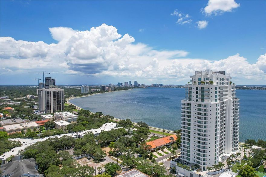 Come see the best views on Bayshore Boulevard with this front facing 3 bedroom + den, 3.5 bath condo with sweeping views of the bay and the sparkling buildings of Downtown Tampa as the backdrop. If you love the daytime views, the nighttime views are even better! Step off the elevator directly into your private foyer and immediately you're immersed in water views. The home features beautiful porcelain tile throughout, gorgeous custom cabinetry, Wolf Induction Cooktop (wired for gas if you want a gas range), and Subzero Refrigerator. This kitchen is open to the Great Room with custom entertainment built-ins and access to the enormous front balcony with plenty of space for al fresco dining, a casual seating area, and chaise lounges. The Primary Bedroom also has access to the front balcony, a large primary bathroom with an oversized shower and separate tub, and a nicely finished walk-in closet. The den/office has access to the 2nd balcony, great for sunsets and views all the way to Downtown St Pete. Each guest suite has a private bath and a large walk-in closet. Tons up upgrades include custom chandeliers, additional can lighting, motorized shades throughout the entire unit, cameras, and a sound system with built-in speakers throughout. The Virage is a luxury high-rise featuring 24/7 concierge, pool overlooking Bayshore, spa, grilling area, fire-pit, club room, meeting room, a large gym, massage room, private dog walk, dog spa, bike room, air-conditioned storage, and 2 guest suites which can be reserved for your guests. Come live the lifestyle you deserve at the Virage Bayshore!